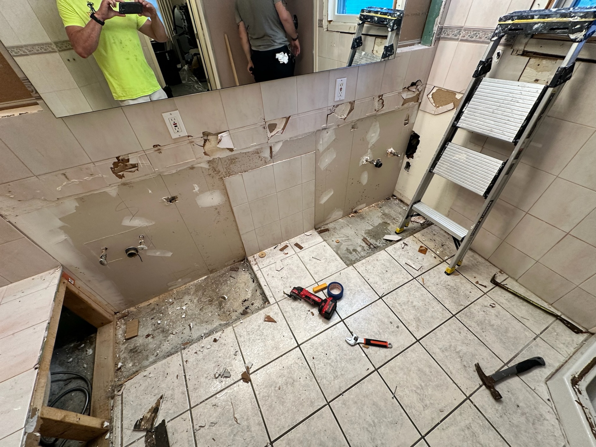 Vanity wall tile and fixtures removed during Metairie master bath demo