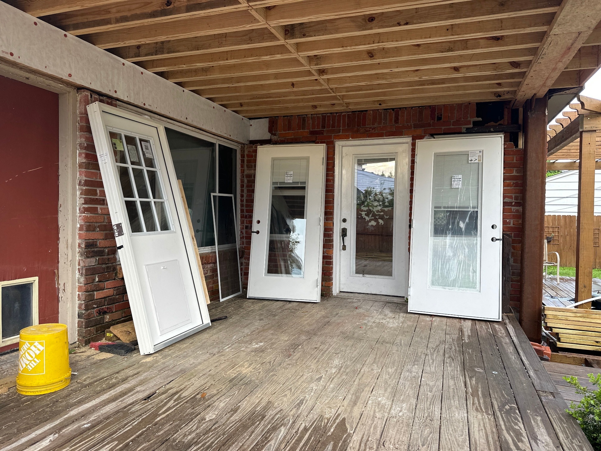 New exterior doors staged under rebuilt covered porch framing at Blanke Street Metairie whole-home remodel