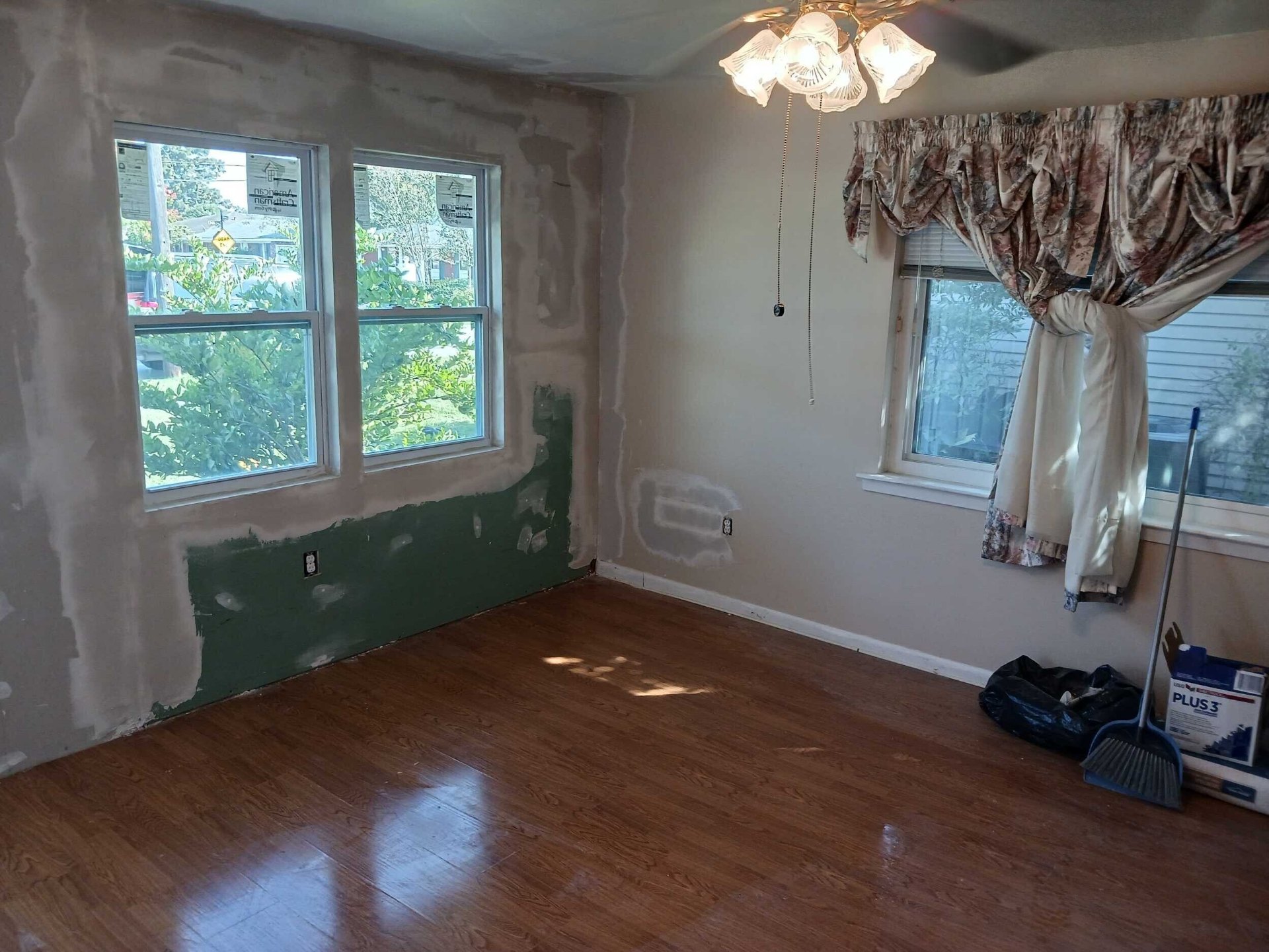 Interior of the Gretna room with drywall mudded, taped, and sanded around the new windows, ready for primer and paint