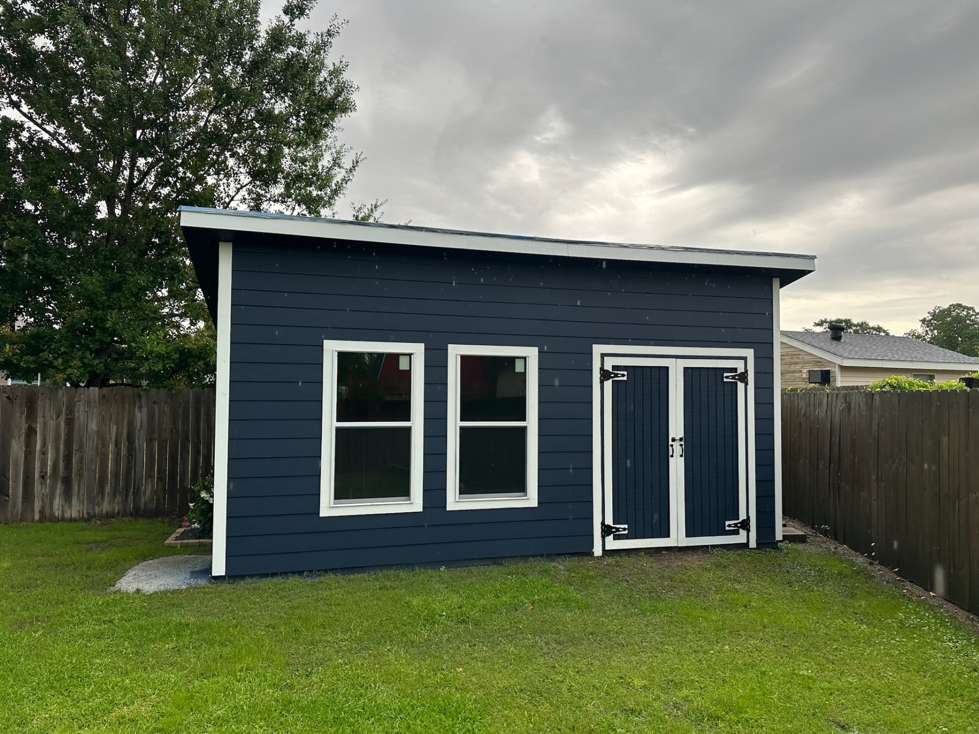 Finished custom shed front elevation in rain Metairie Louisiana