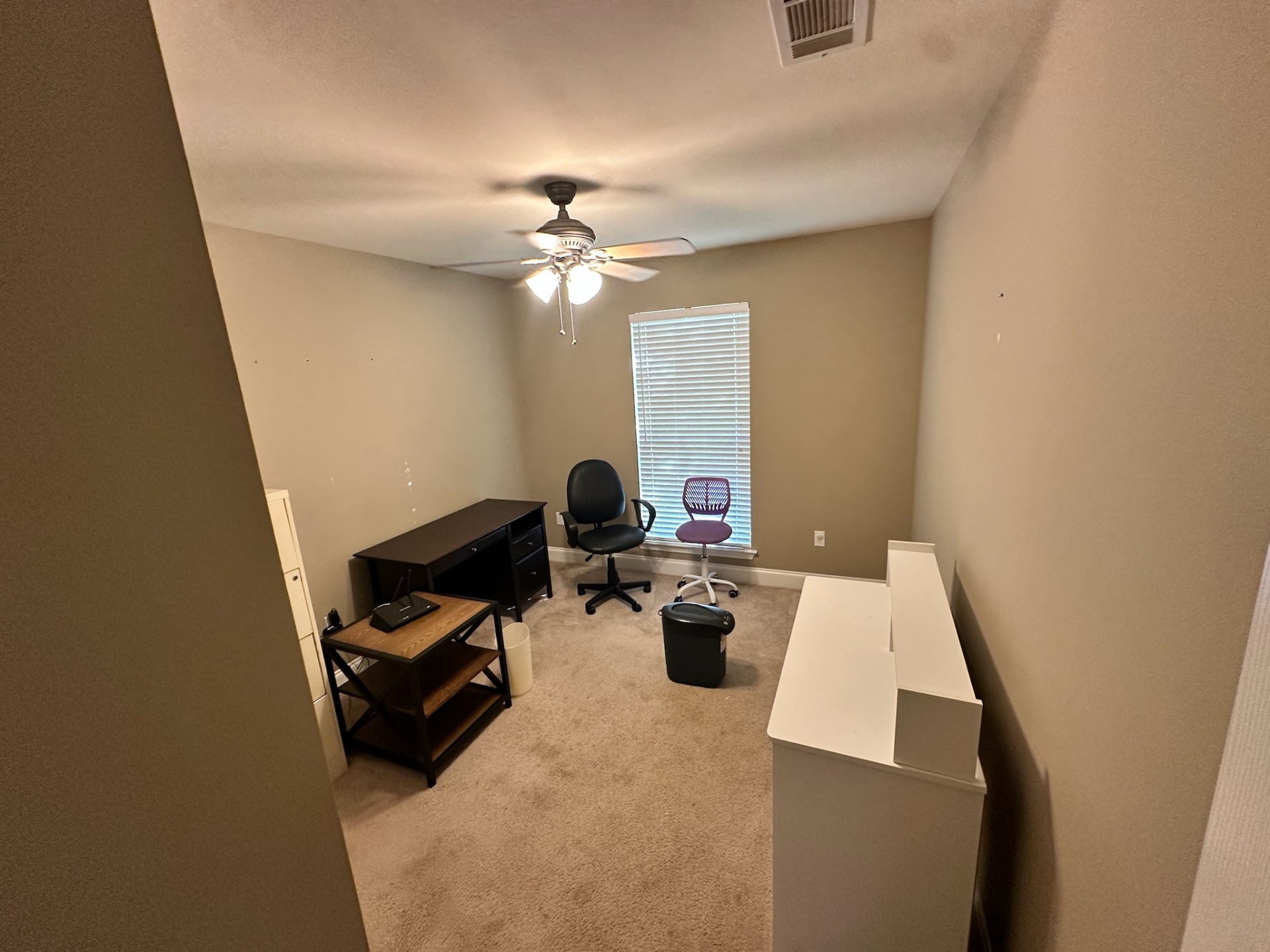 Before — home office bedroom with worn carpet in Gonzales