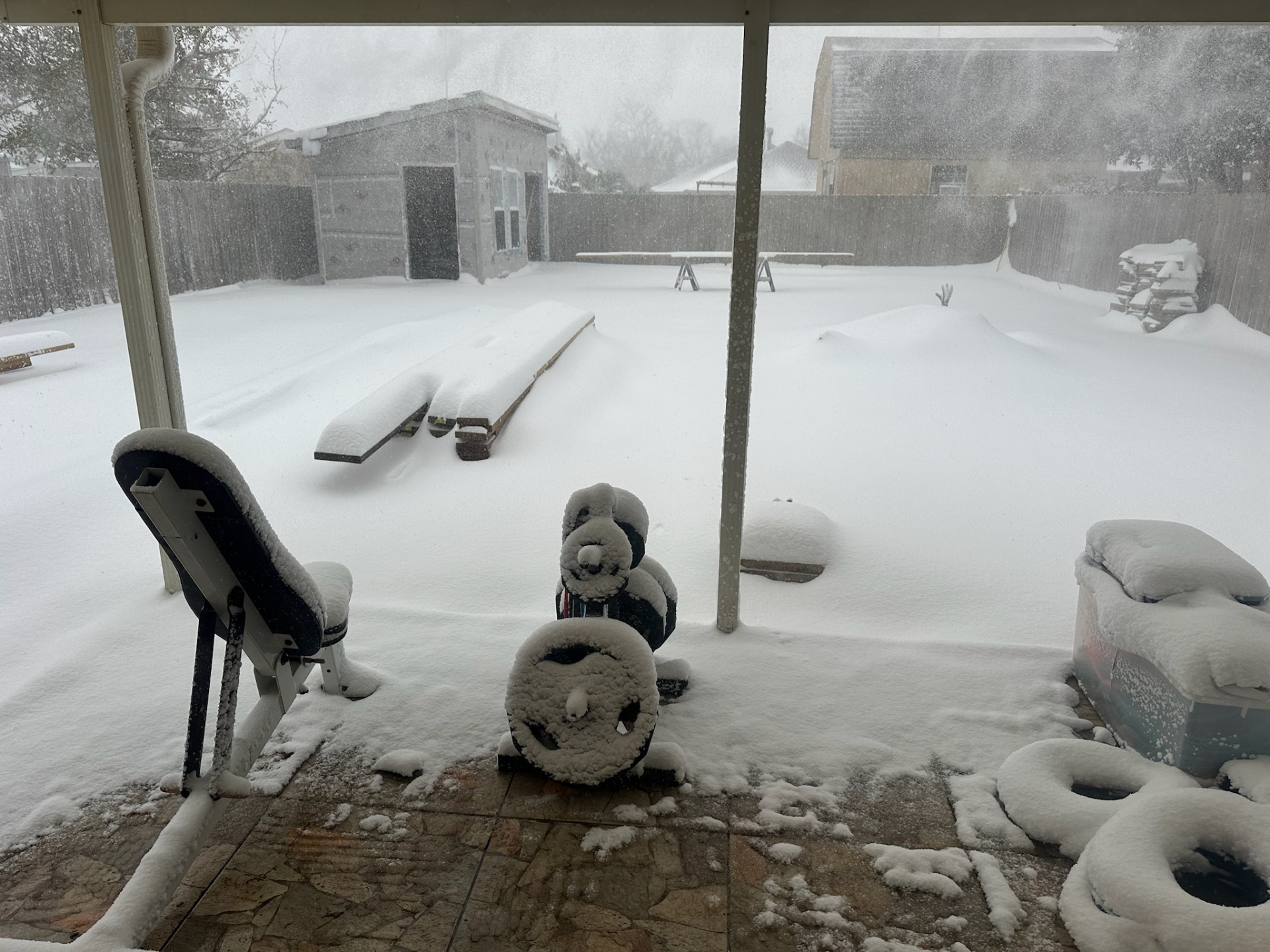 Distance shot of Metairie outbuilding during heavy snow showing structure performing through unusual winter load