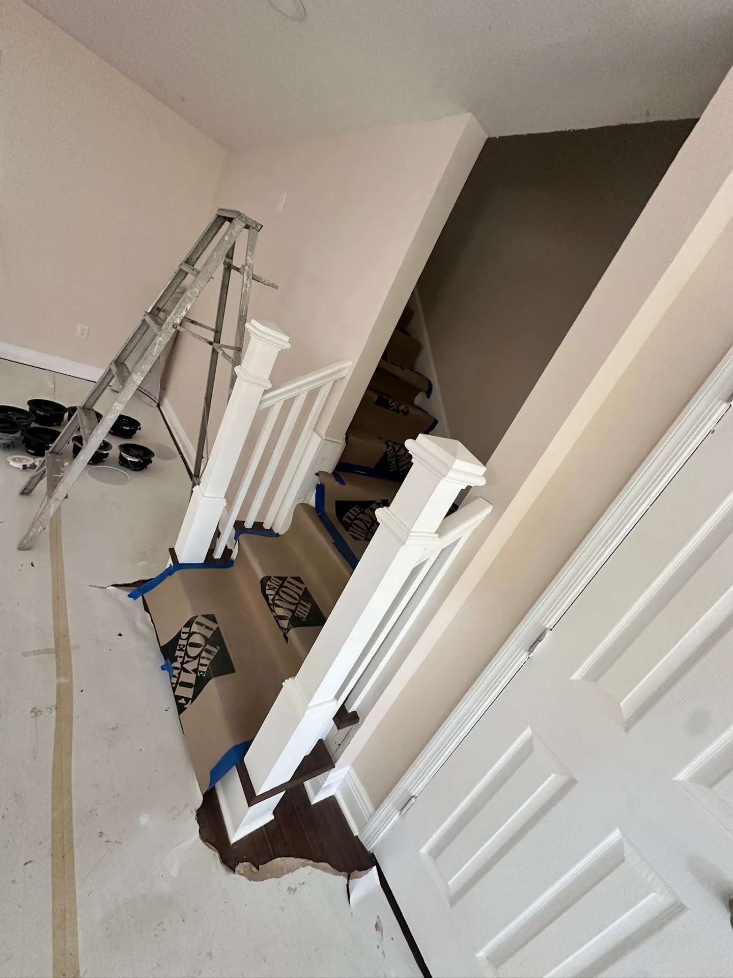 Finished stair balustrade at Blanke Street Metairie home with painted white newel posts, balusters, and stained hardwood treads