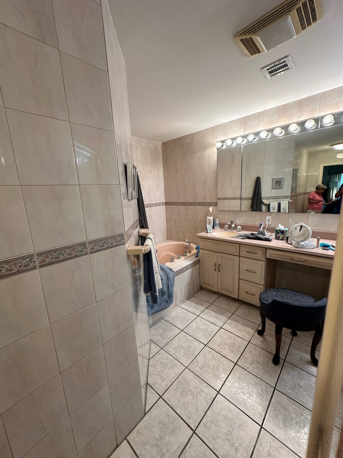 Before — peach jetted corner tub and old vanity in Metairie master bath