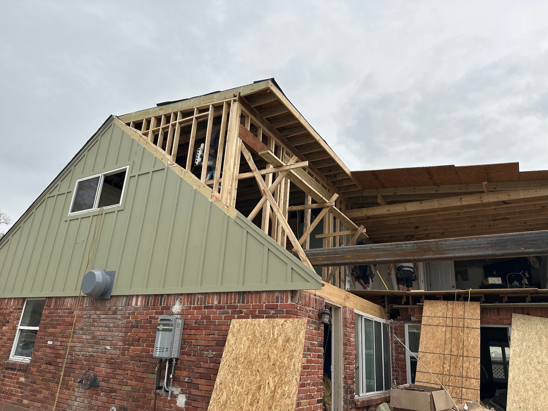 New second-story framing tied into original brick veneer at Blanke Street Metairie whole-home remodel and addition