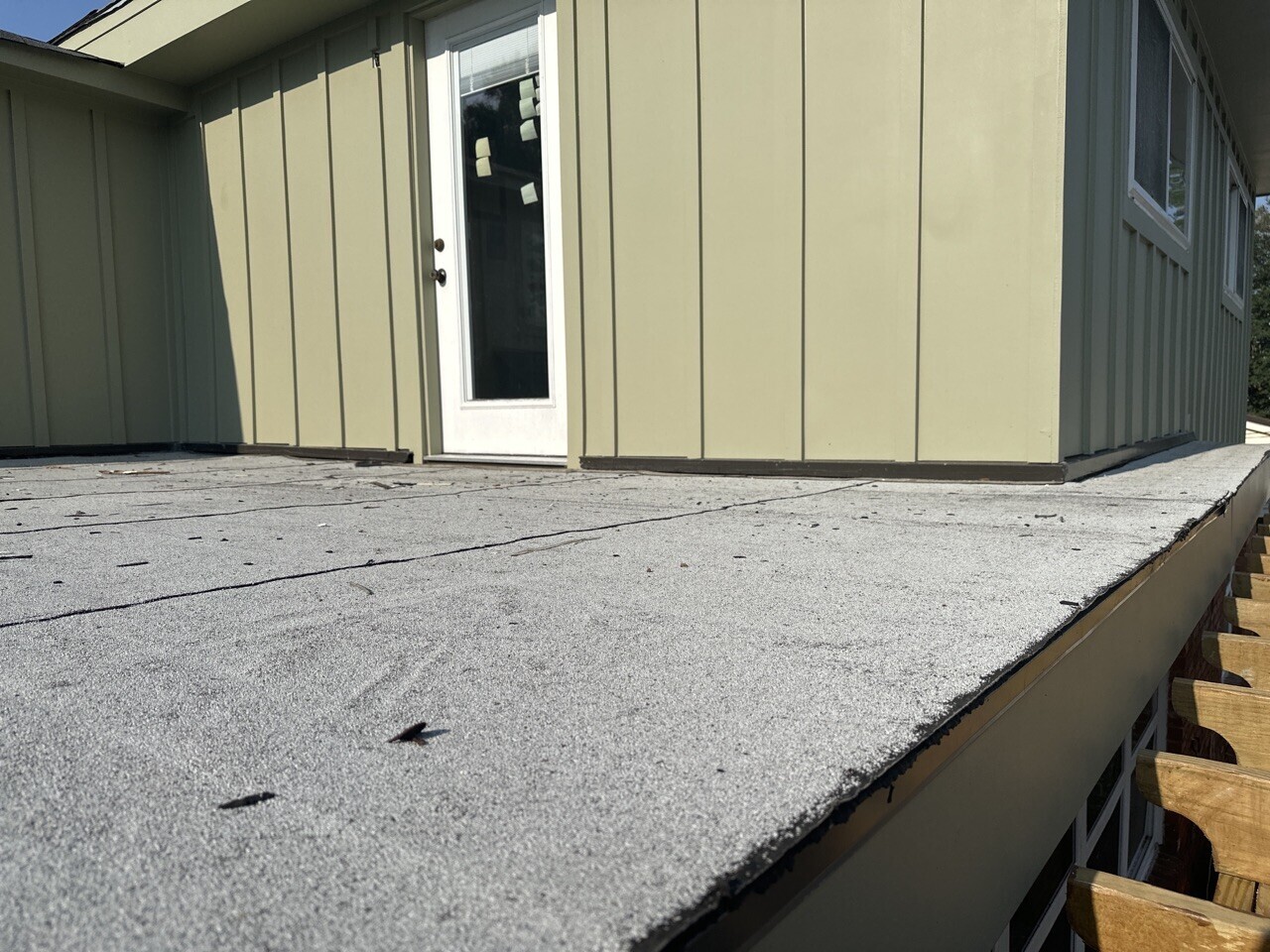 Detail of new modified bitumen flat roof over covered porch at Blanke Street Metairie whole-home remodel