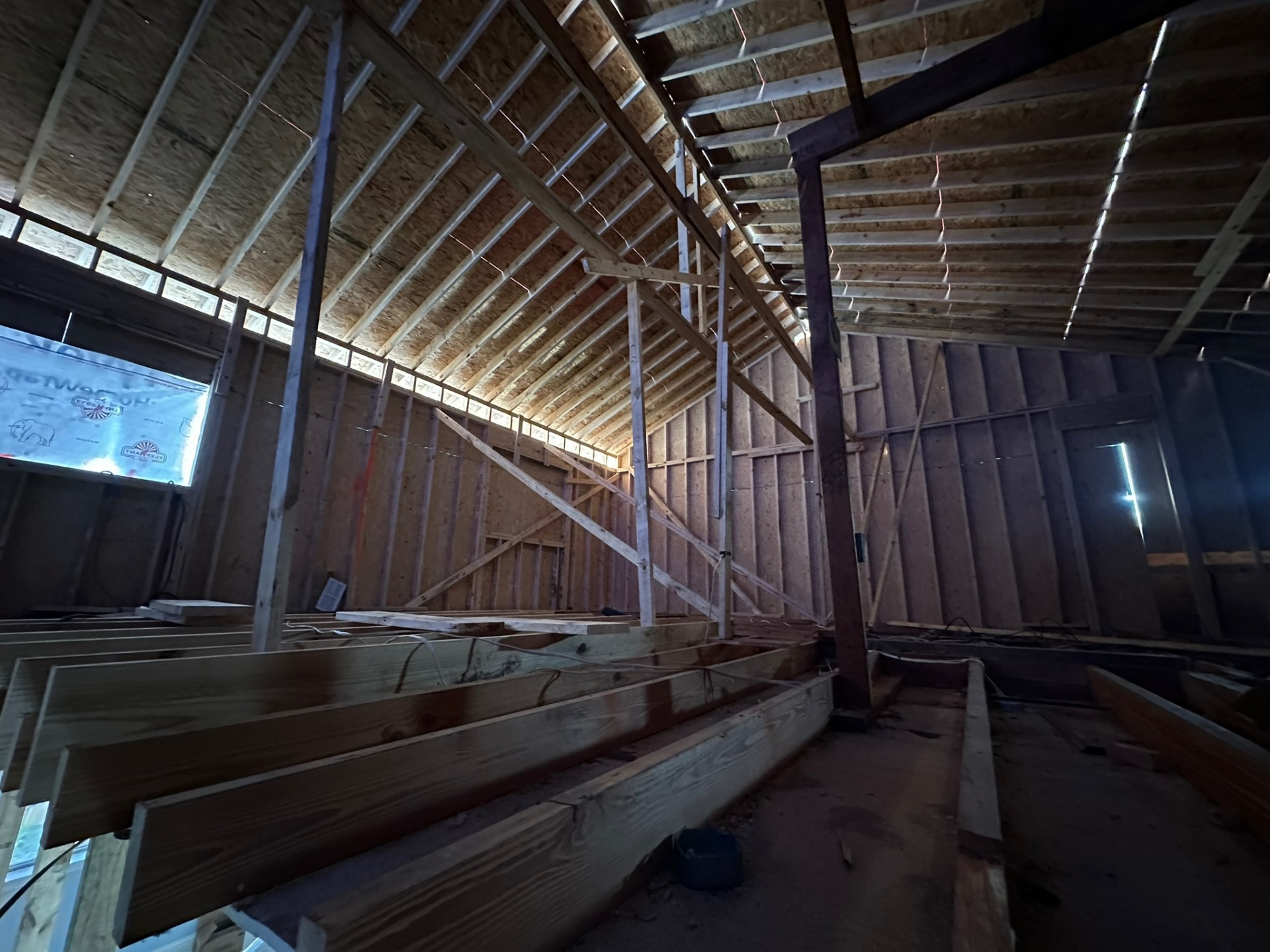 Interior view from inside the new second-floor framing on Metairie addition showing new rafters, knee walls and bracing