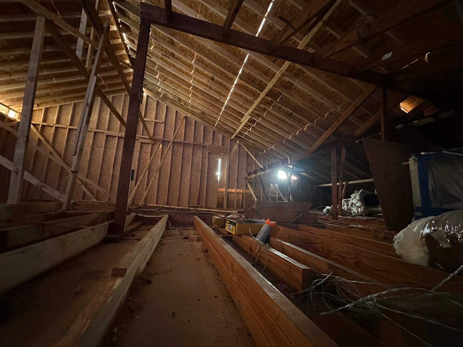 Interior ridge view of new second-floor framing on Metairie home addition with new rafters meeting at the ridge beam