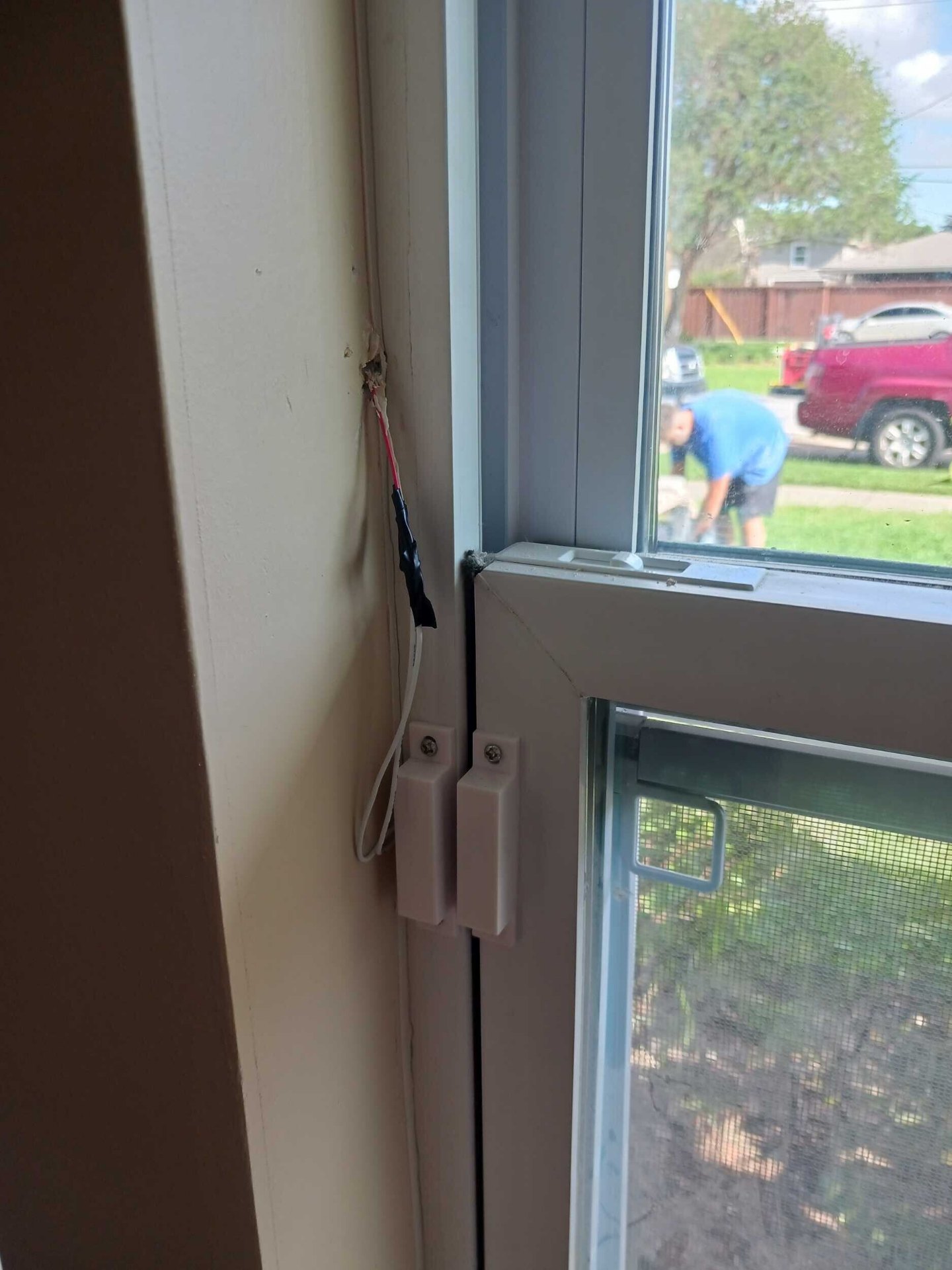 Existing alarm door and window sensor reconnected to the new window and trim in the rebuilt Gretna living room
