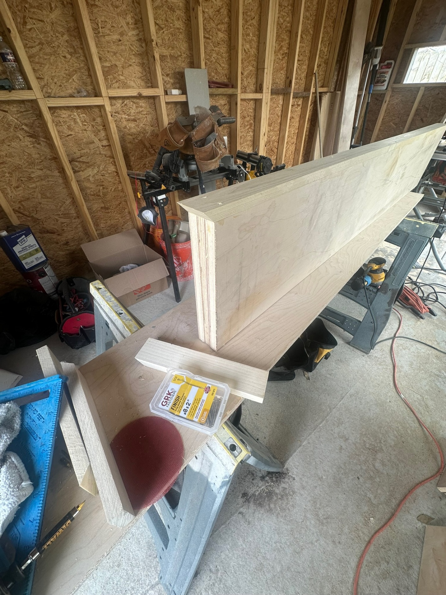 Detail of a custom solid maple floating shelf box assembled with mitered returns and finish screws in the Cajun Home Services shop for a Meraux Louisiana project