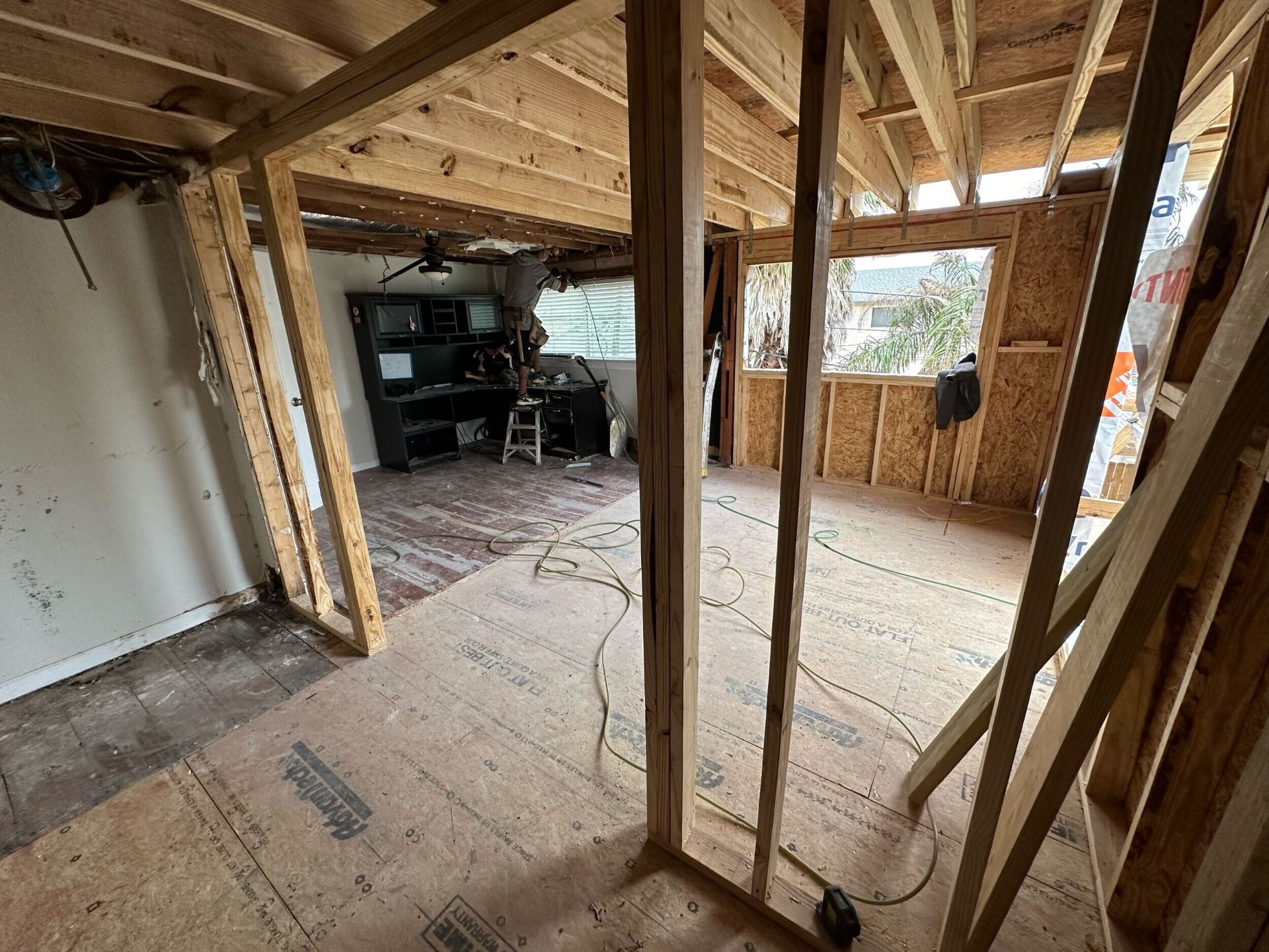 Interior framing view through new door openings between rooms during Blanke Street Metairie whole-home remodel