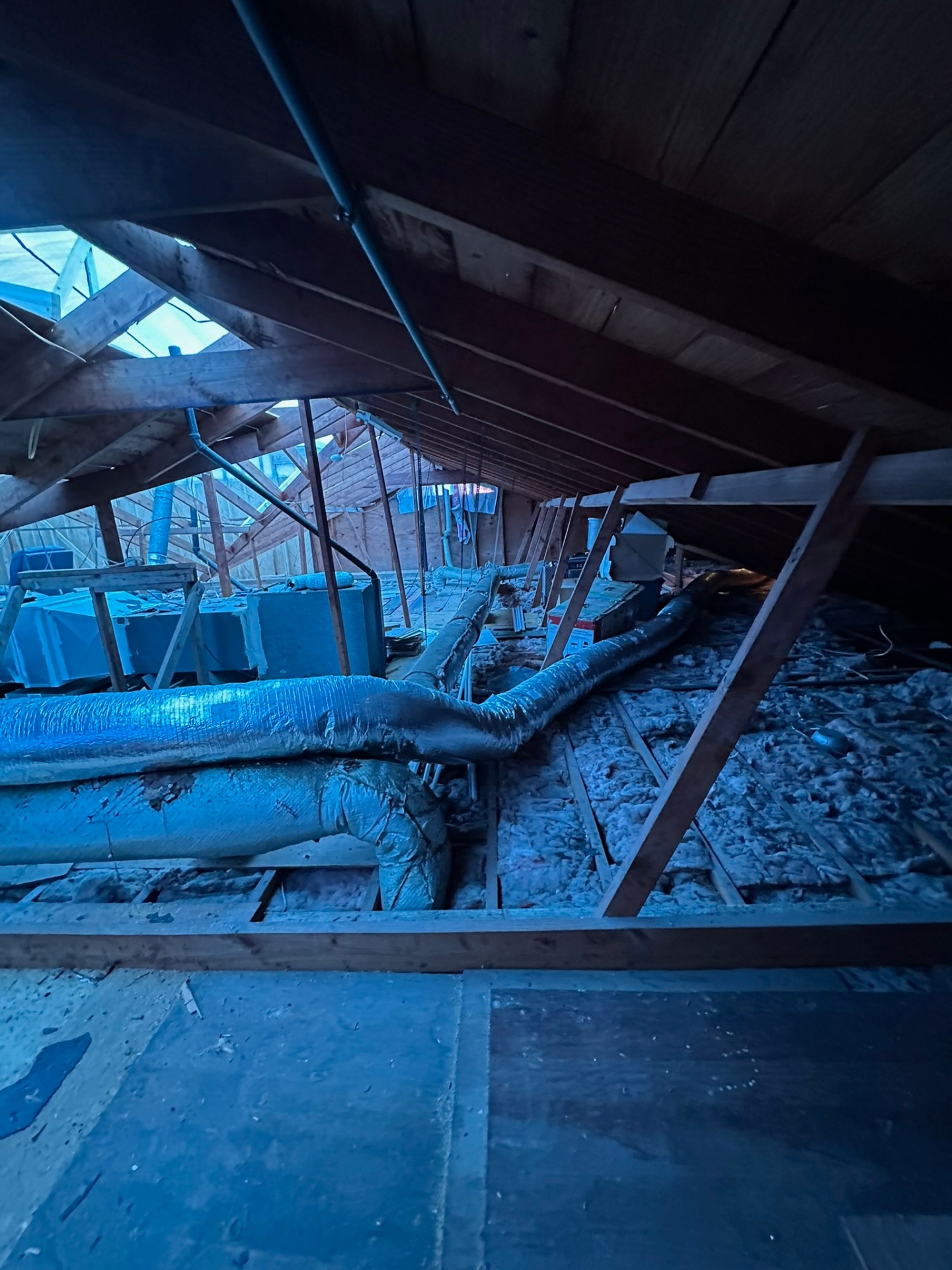 Original Metairie attic with HVAC ductwork and rafter framing documented before second-story addition