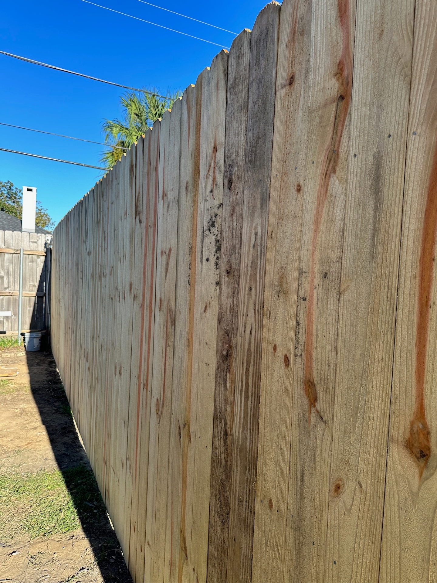Closeup detail of new dog-eared picket fence in Metairie Louisiana