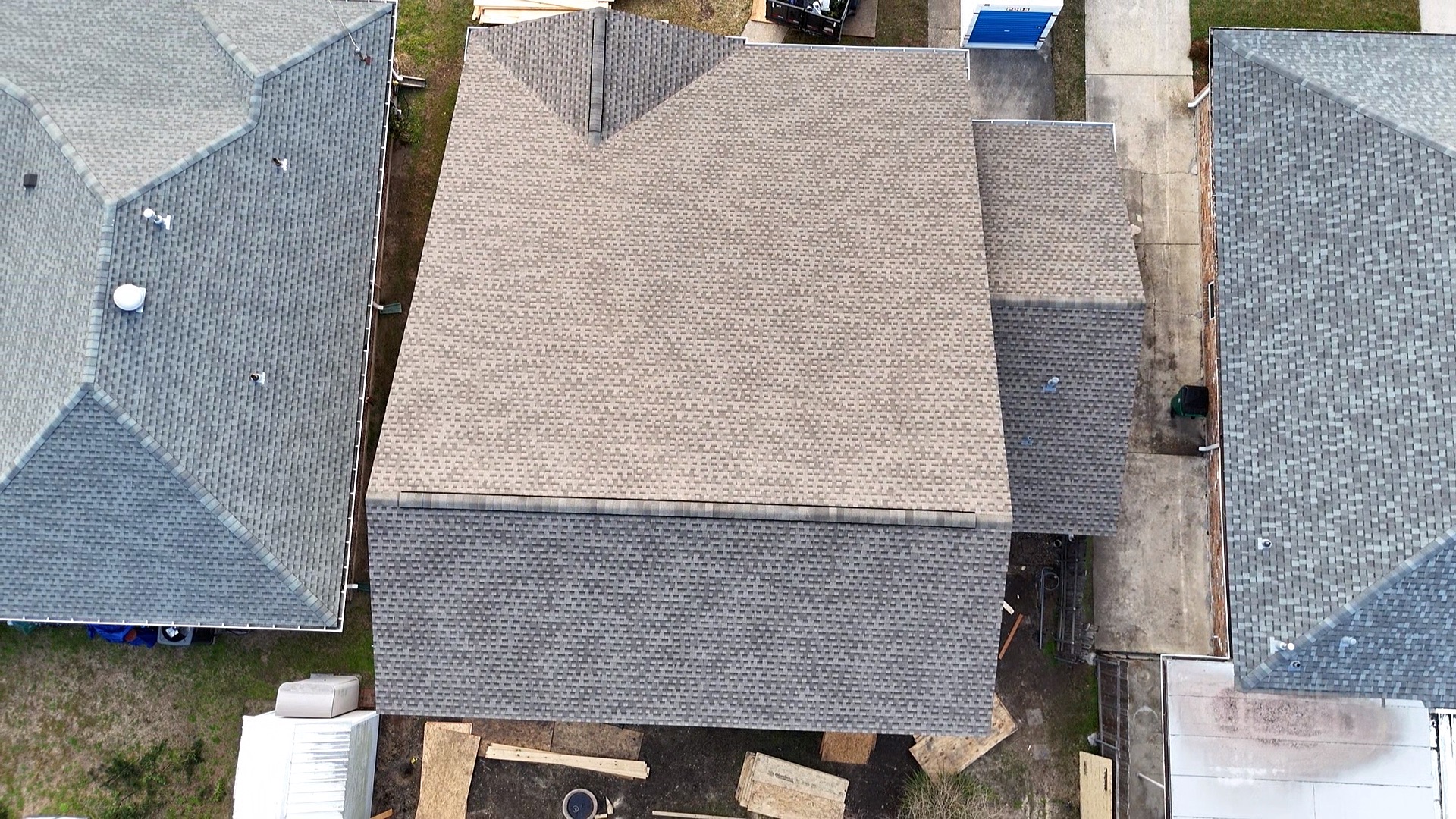 Aerial view of completed hip and ridge roof over second-floor addition in Metairie Louisiana
