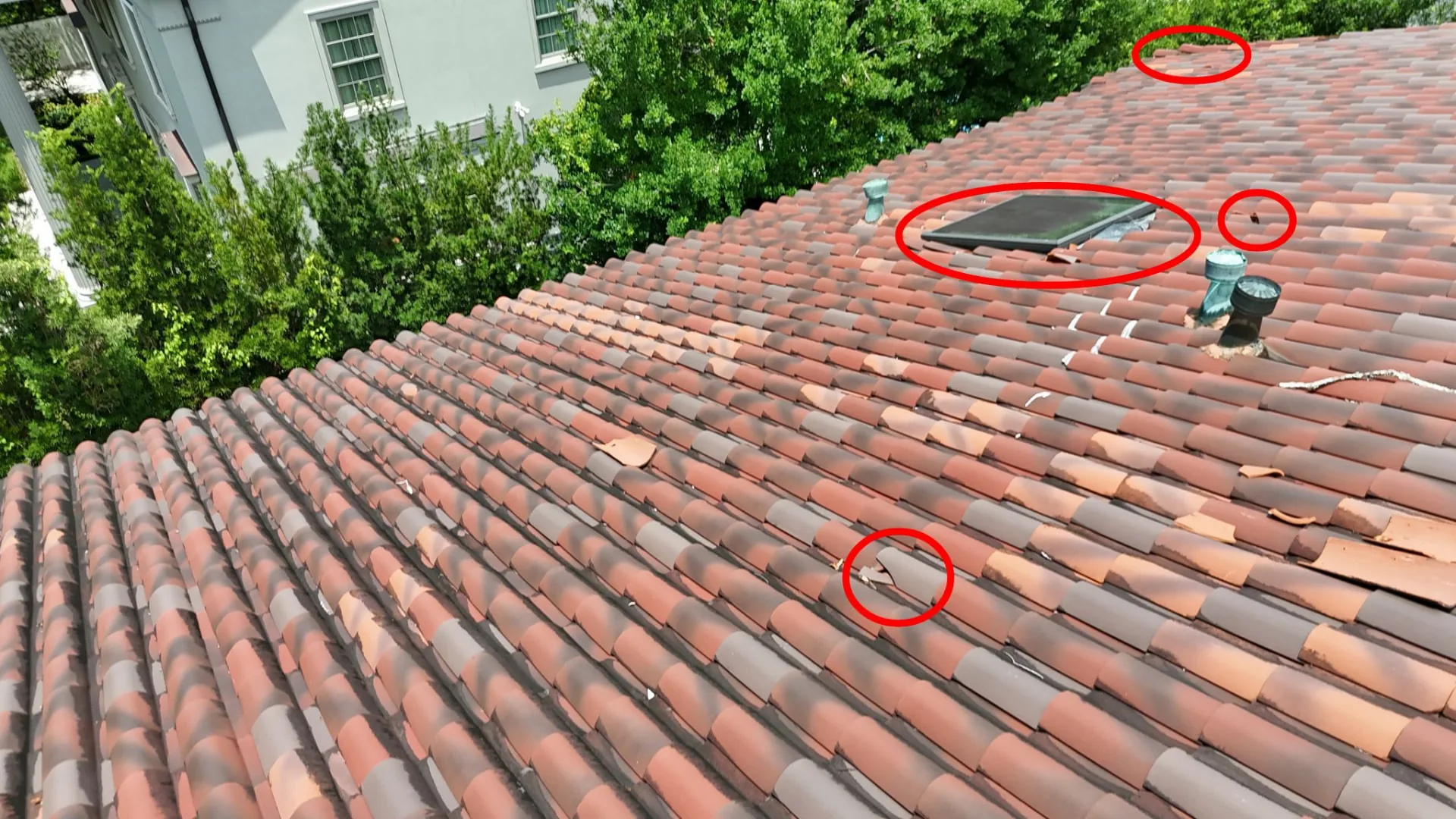 Drone inspection photo marking broken and slipped terra cotta roof tiles near a skylight on a Northline area home in Metairie Louisiana