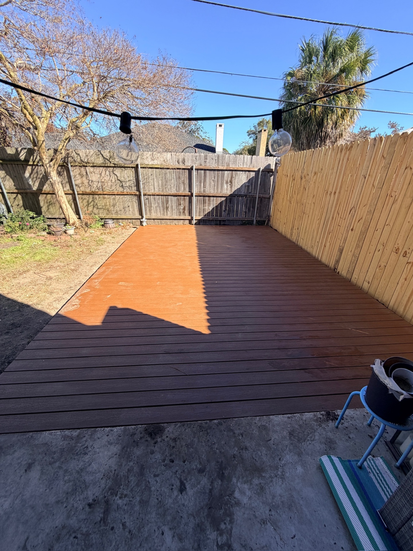 Finished Trex composite deck with string lights in Metairie Louisiana backyard on Bissonet Dr