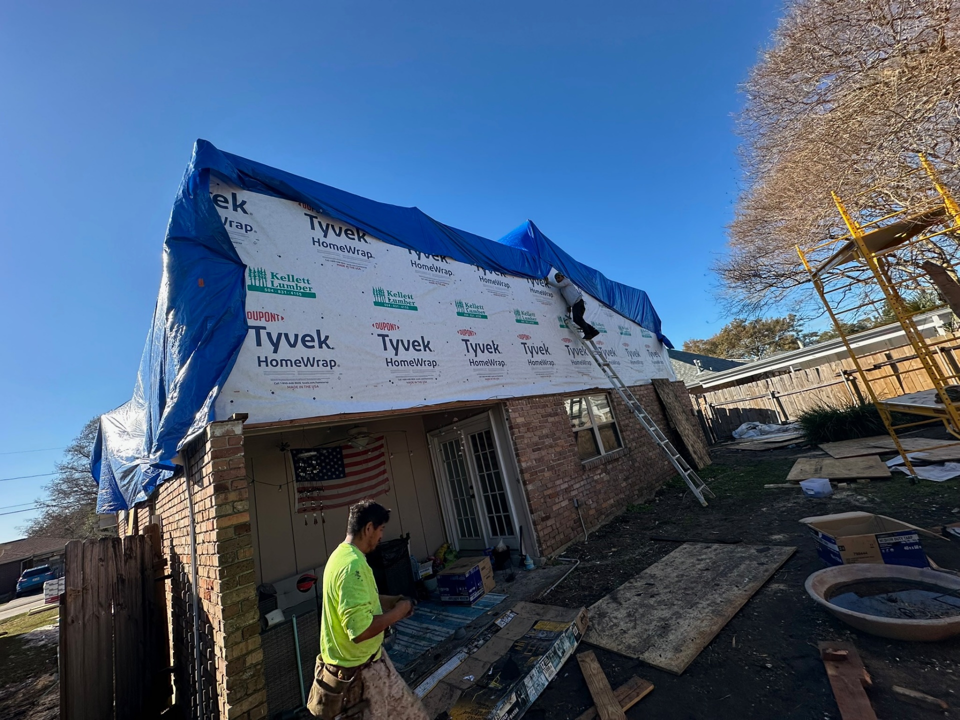 Tyvek house wrap installed over second-floor sheathing on Metairie home addition before siding and windows