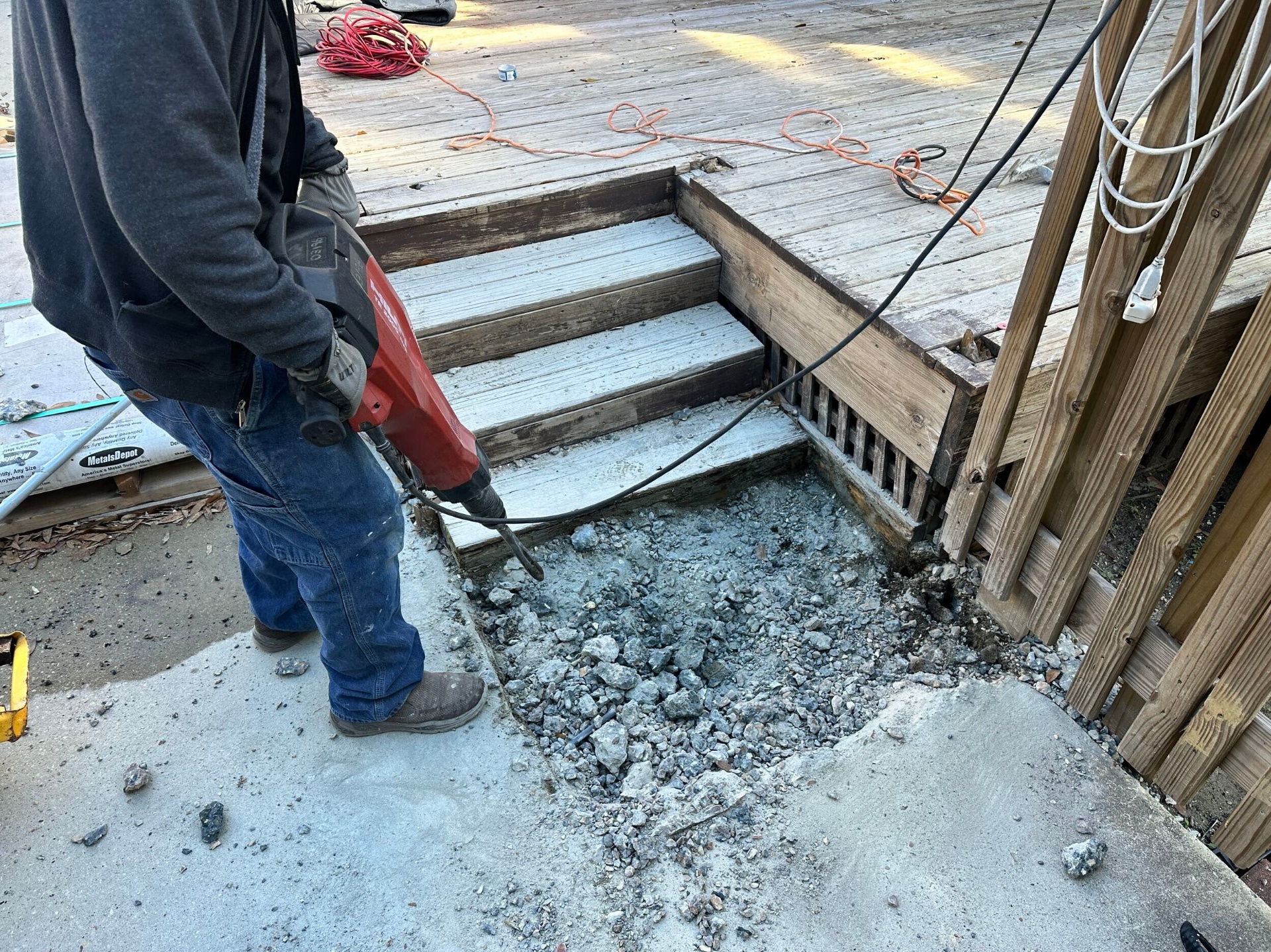 Concrete pad demo at rear of Blanke Street Metairie home during foundation reinforcement prep