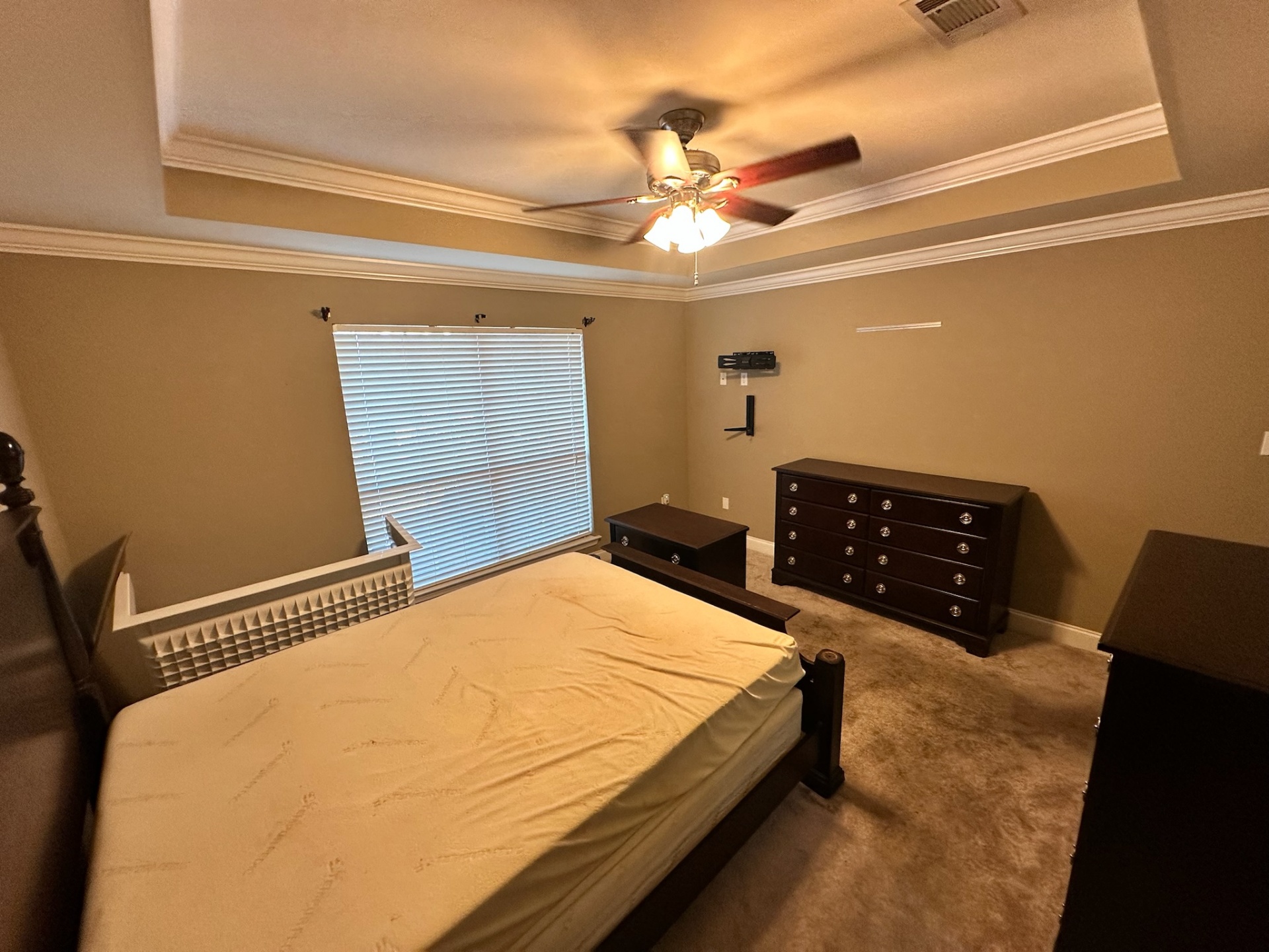 Before — secondary bedroom carpet with tray ceiling in Gonzales Louisiana