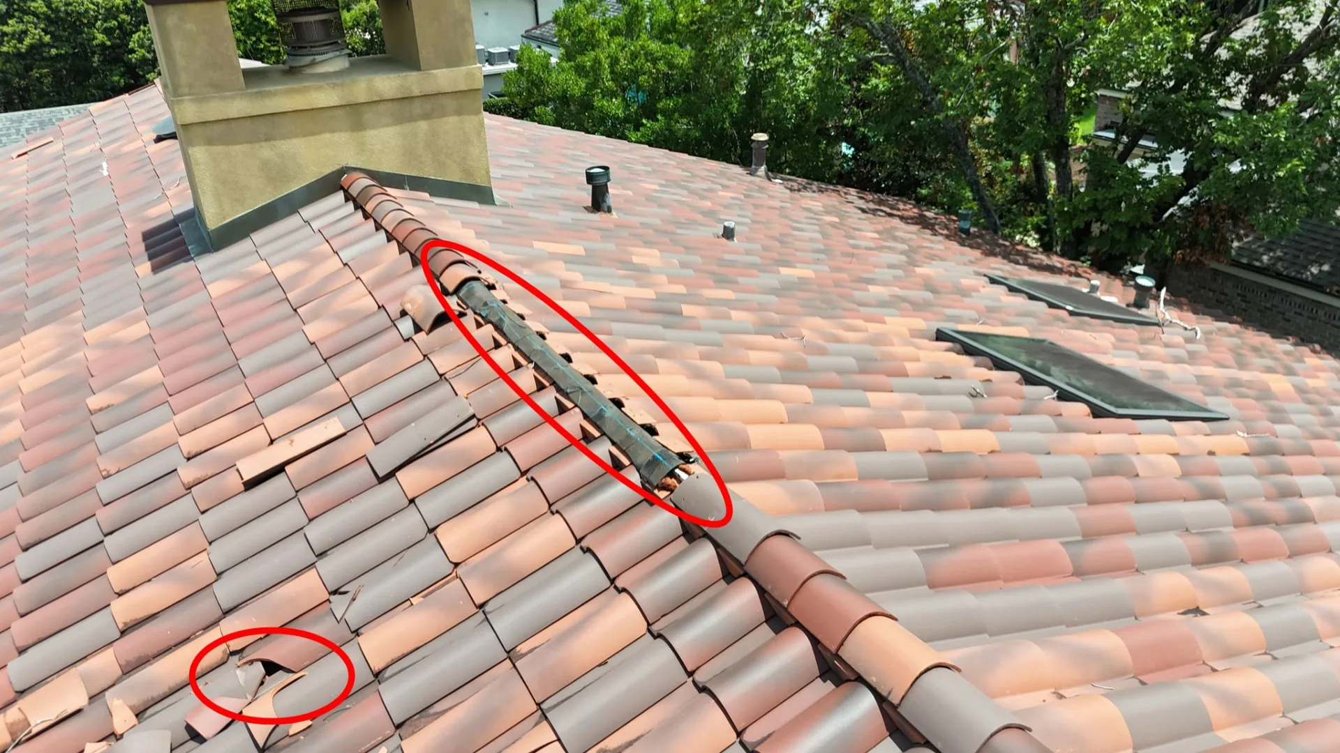 Drone photo marking damaged ridge and hip terra cotta tiles with exposed flashing on a Metairie Louisiana home