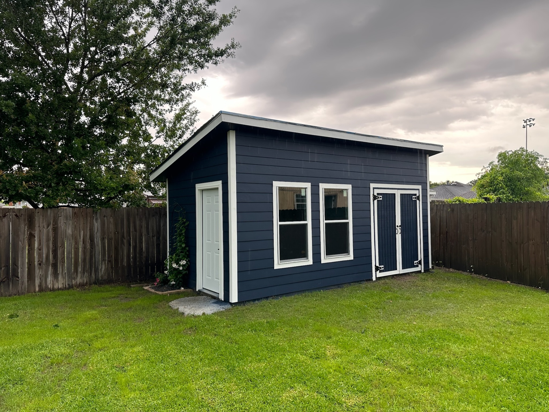 Finished custom Hardie-siding shed three-quarter view in Metairie Louisiana