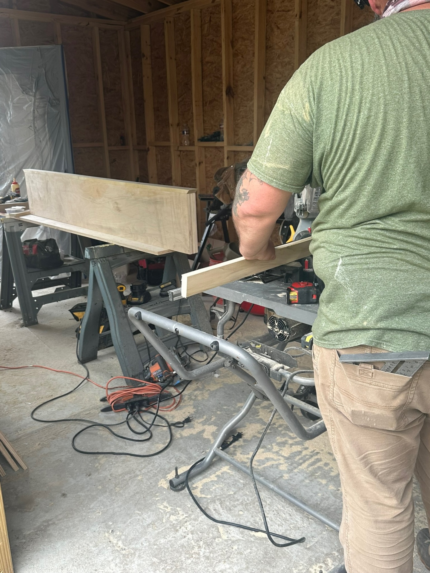 Cajun Home Services carpenter cutting solid maple cleat stock on a DeWalt miter saw during custom floating shelf fabrication for a Meraux LA home