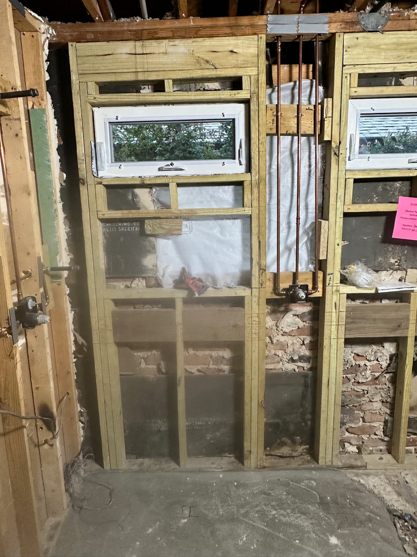 New pressure-treated framing with two awning windows and copper shower supply in Metairie master bath