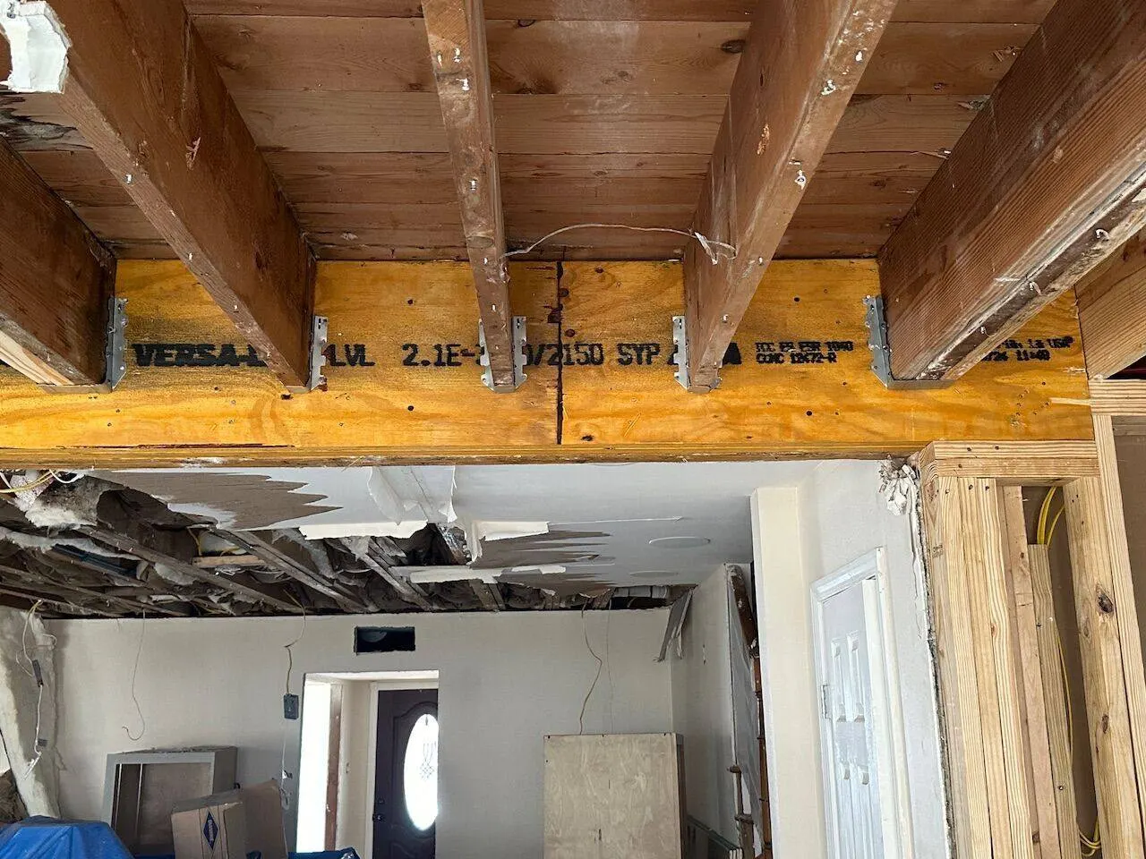 LVL engineered beam with joist hangers supporting second floor framing