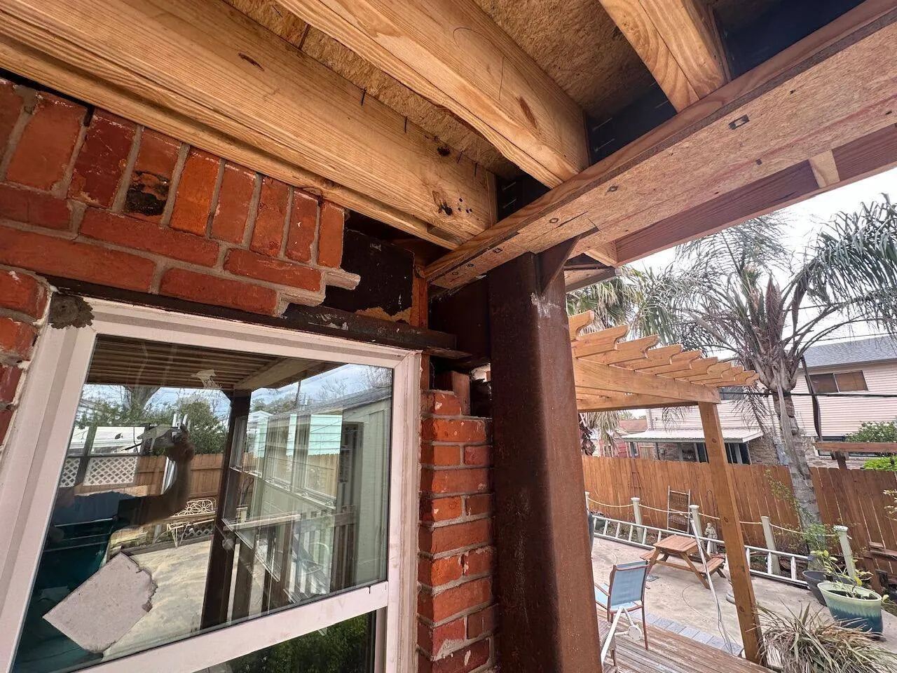 Steel beam to wood framing connection at brick wall during structural renovation