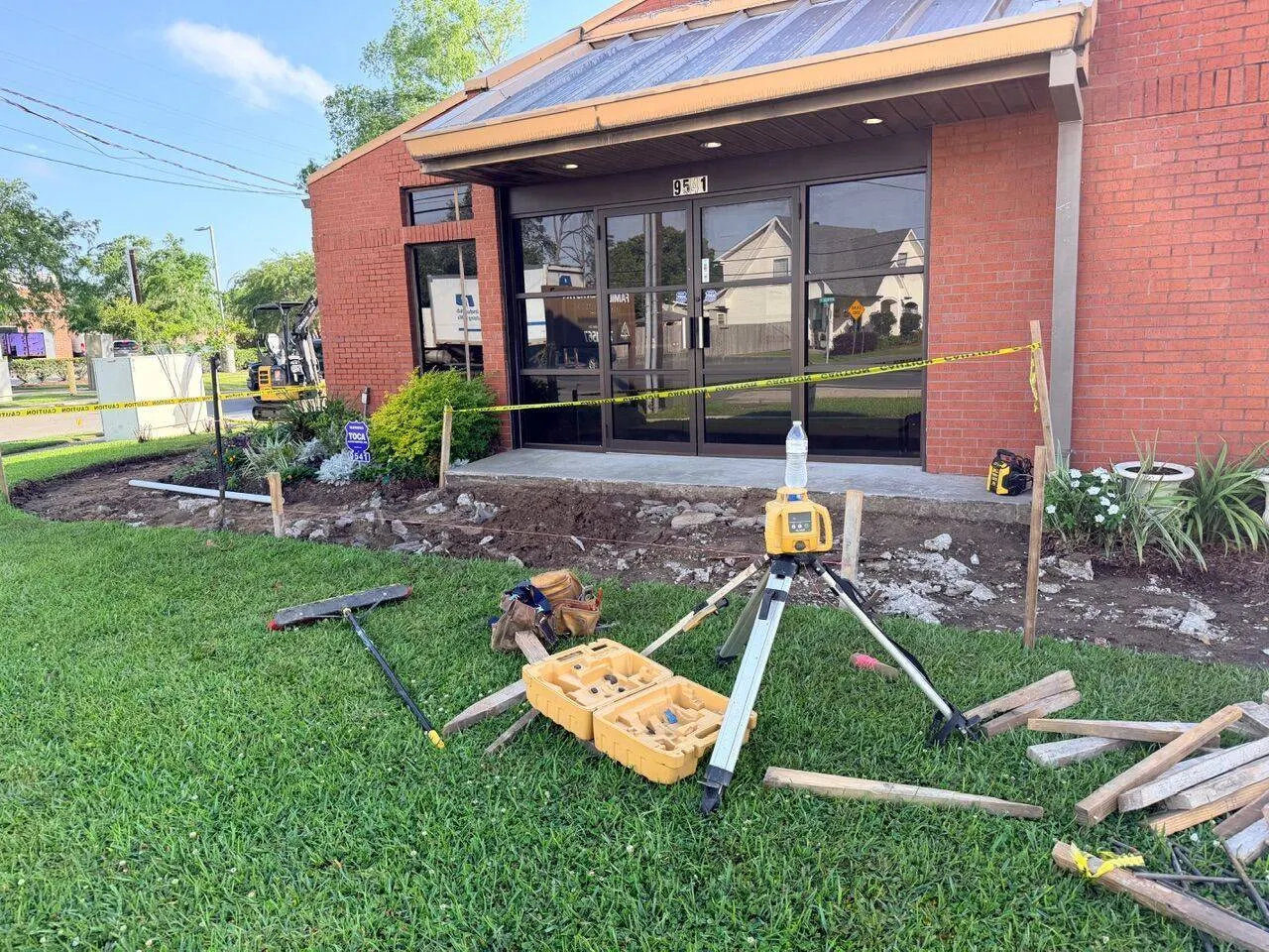 Site prep and surveying with rotary laser level for commercial concrete sidewalk forming at dentistry office in River Ridge Louisiana