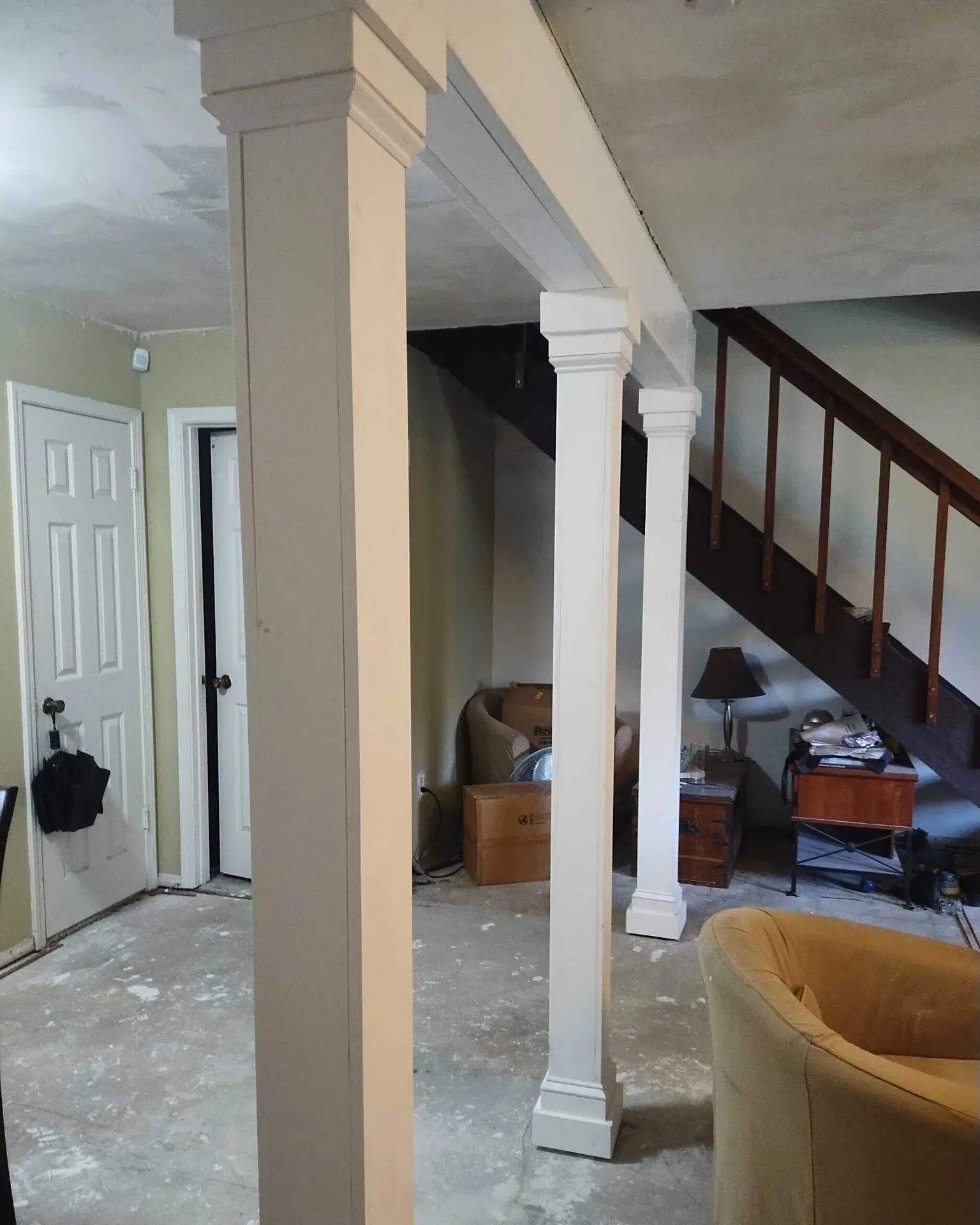 Gretna LA two-story entry with newly clad architectural columns featuring custom decorative mouldings at top and bottom caps, transforming raw posts into finished trim work by Cajun Home Services