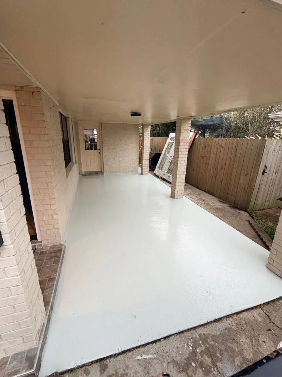 Freshly painted patio with clean concrete floor completed for property turnover