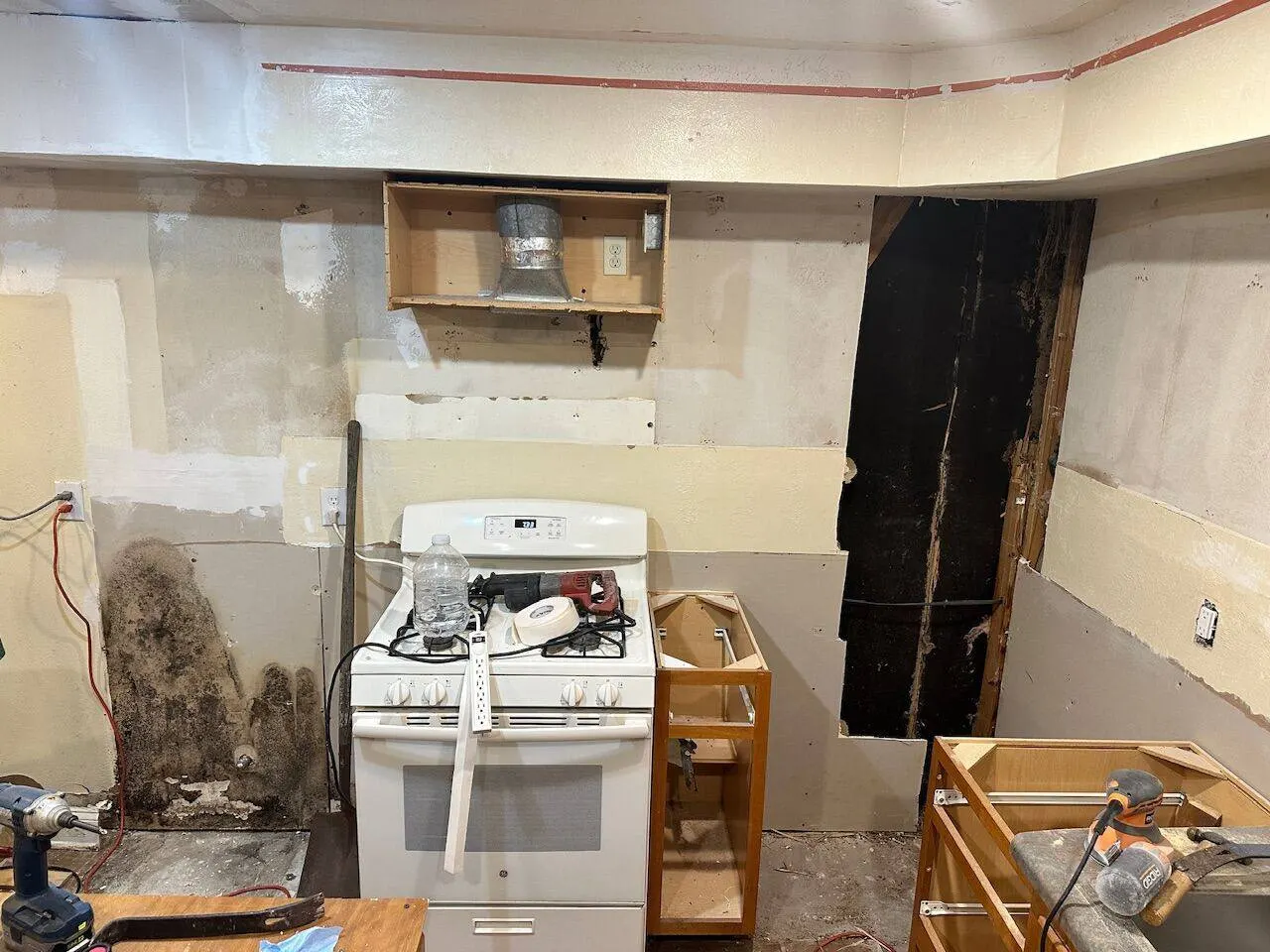 Kitchen demolition with mold on walls and exposed ductwork during renovation in Metairie Louisiana