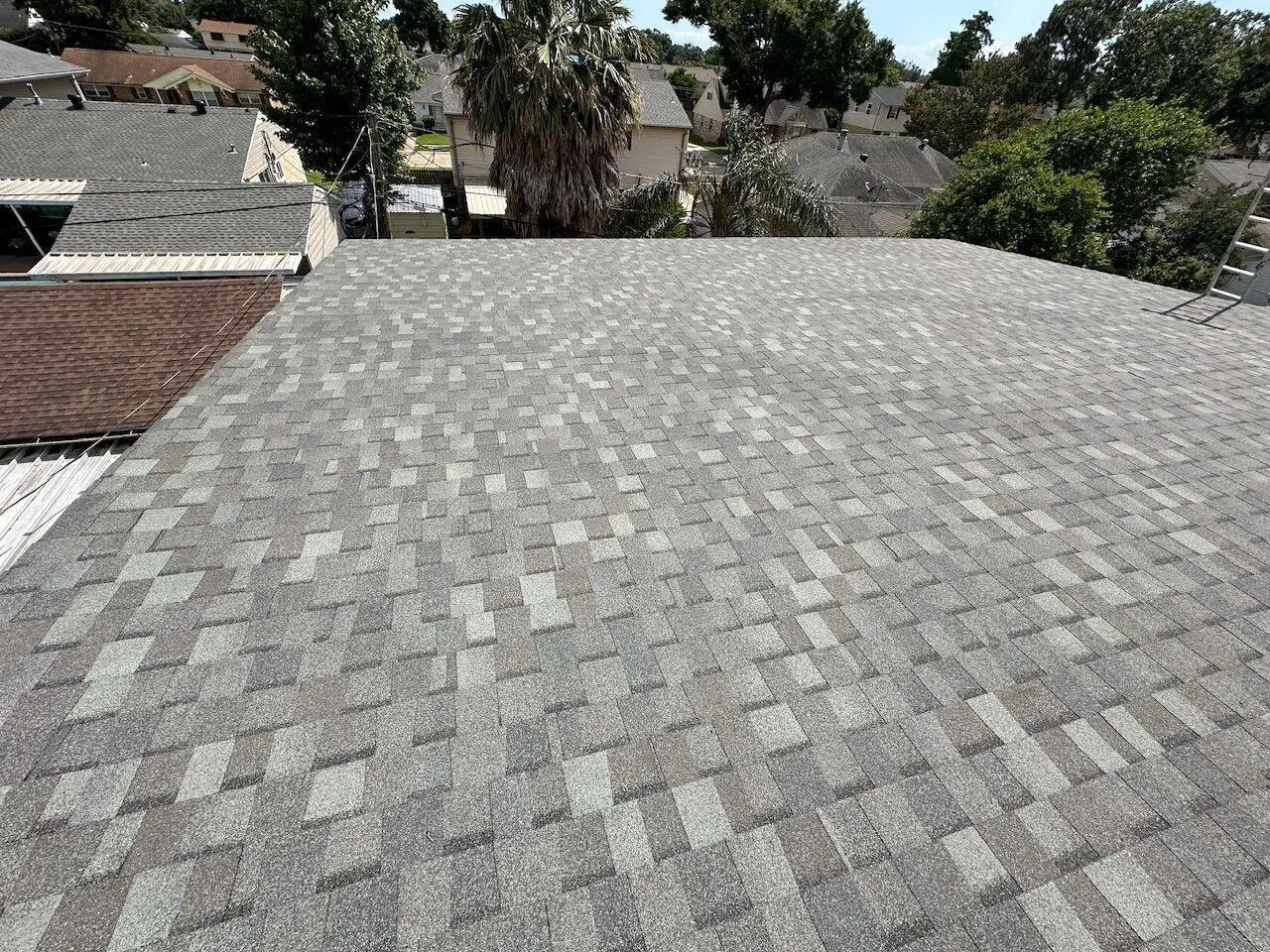 Completed architectural shingle roof with neighborhood view in Metairie Louisiana
