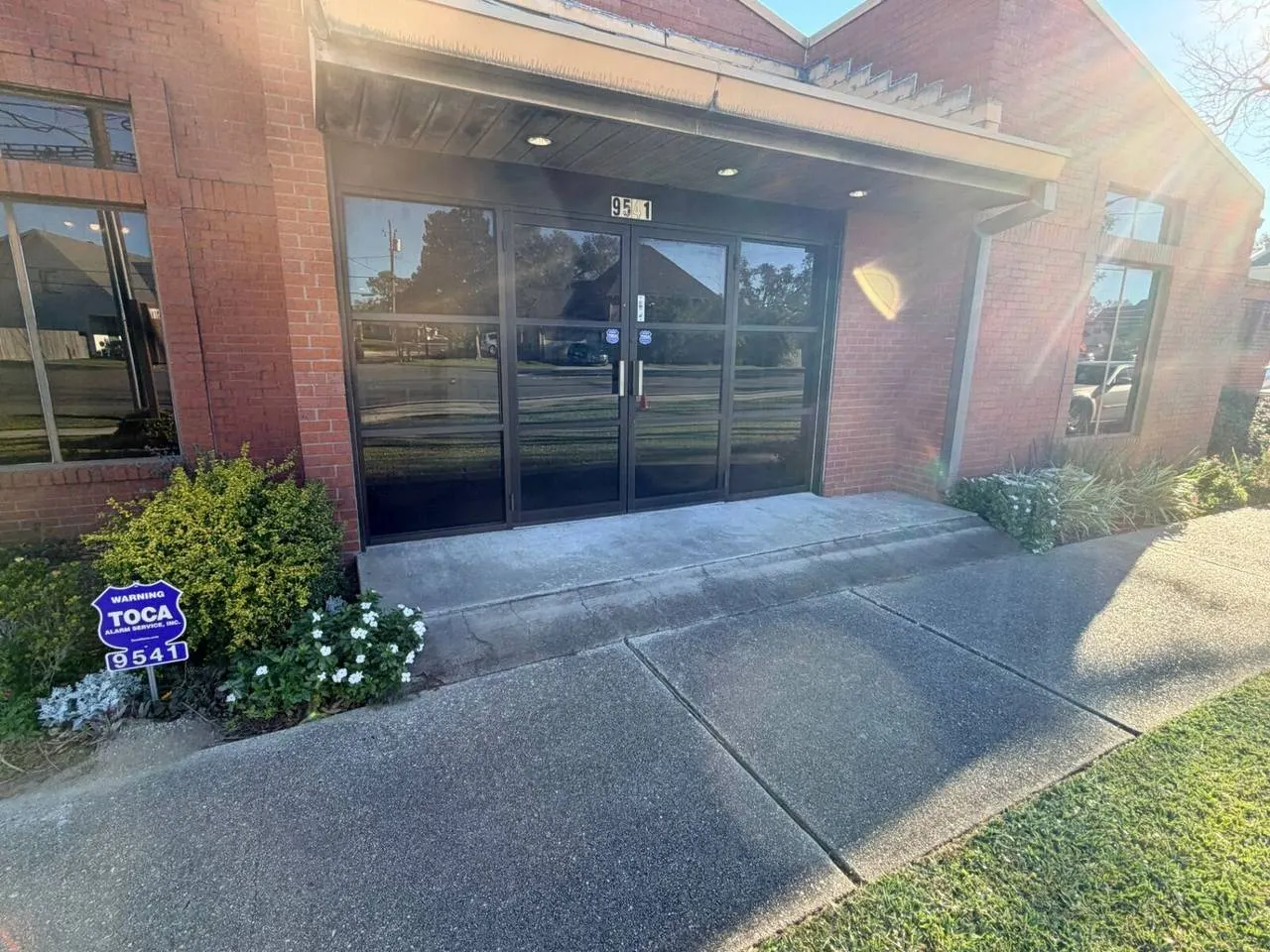 Uneven concrete transition at front entrance before ADA ramp replacement on Jefferson Highway in Jefferson Parish Louisiana