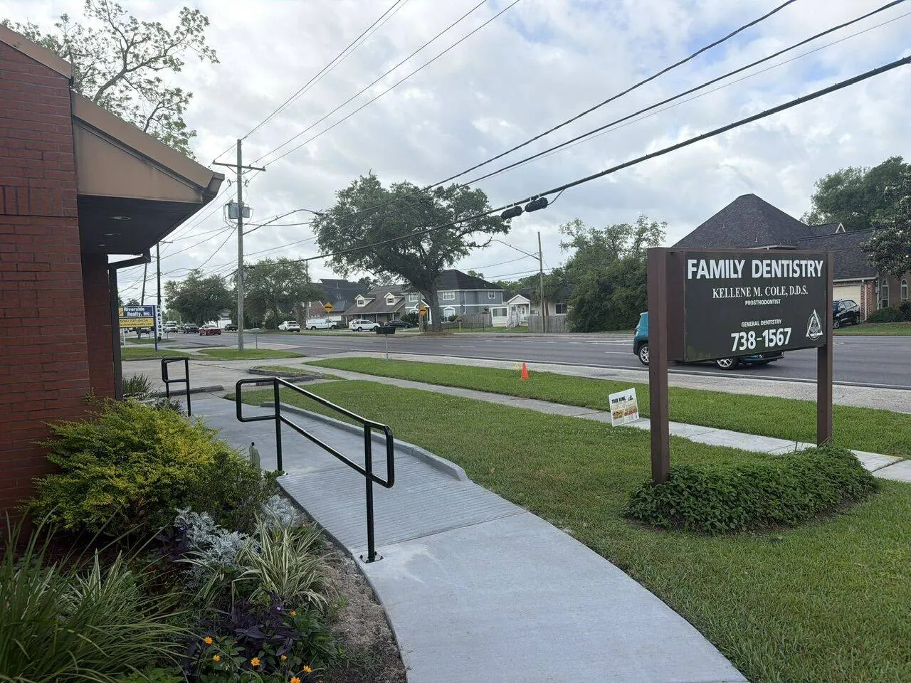 Street level view of completed ADA sidewalk and ramp replacement with handrails at Family Dentistry on Jefferson Highway in Jefferson Parish Louisiana