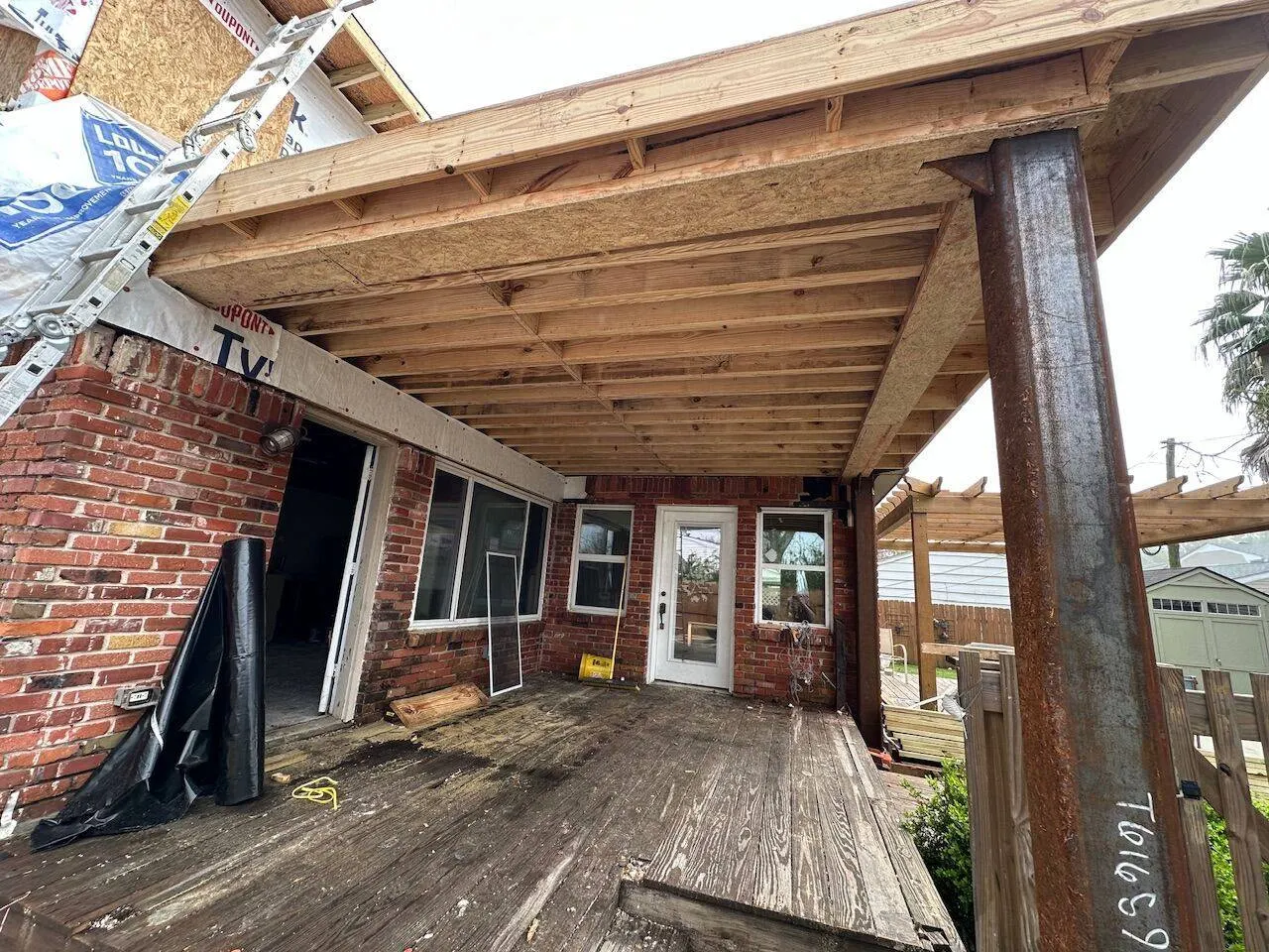 Second floor framing underside with steel column support during home addition in New Orleans