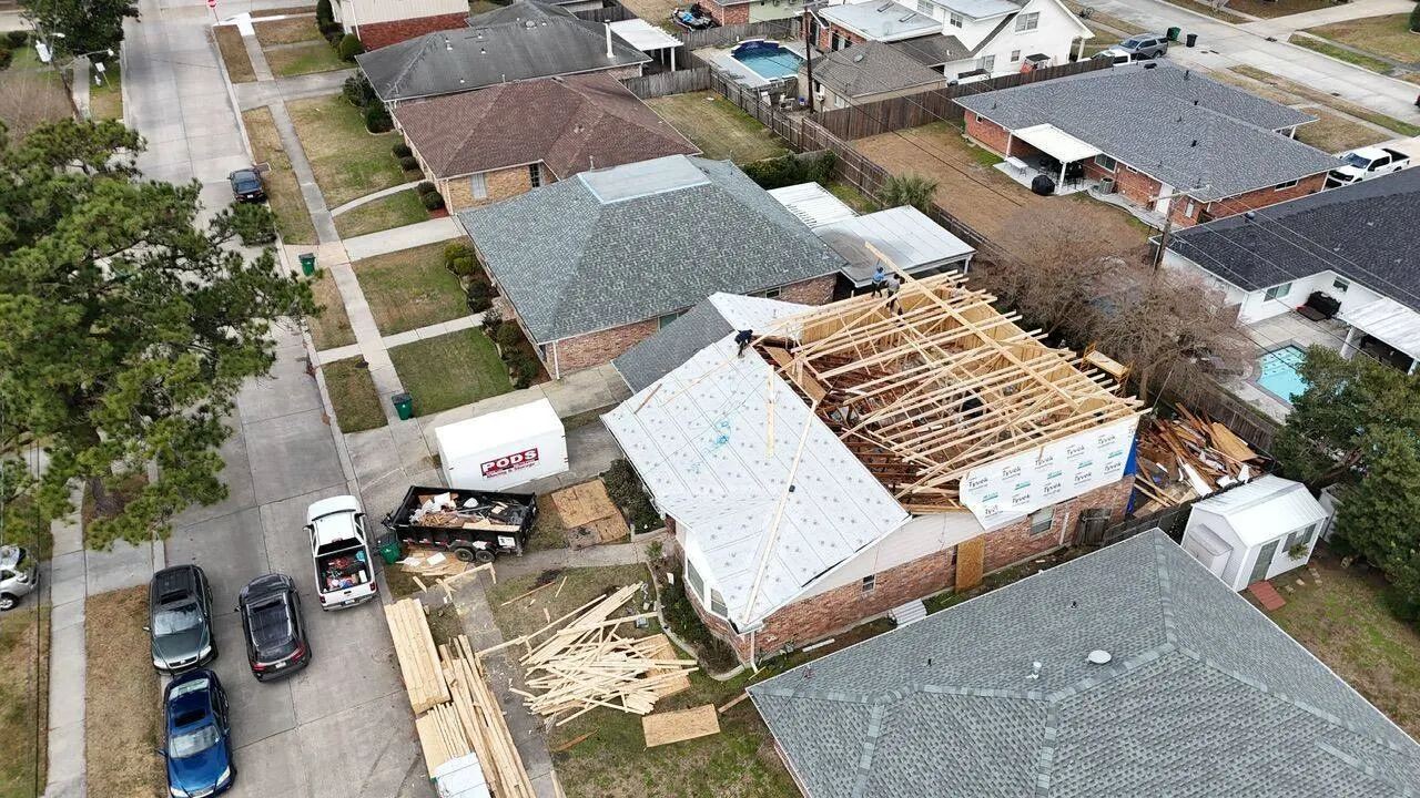 Aerial drone view of second story addition with roof truss framing and Tyvek house wrap in Metairie