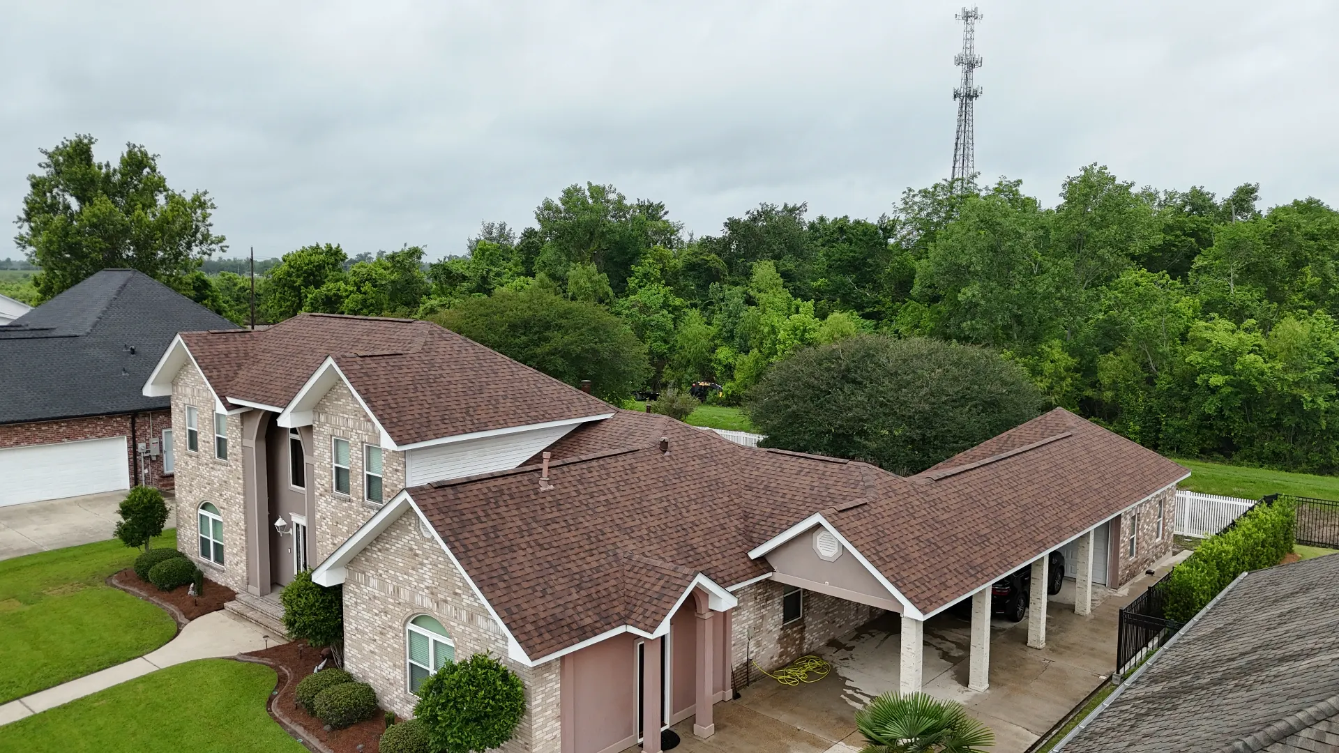 Same Destrehan Louisiana brick home photographed from a matching aerial angle after Cajun Home Services installed a new architectural shingle roof