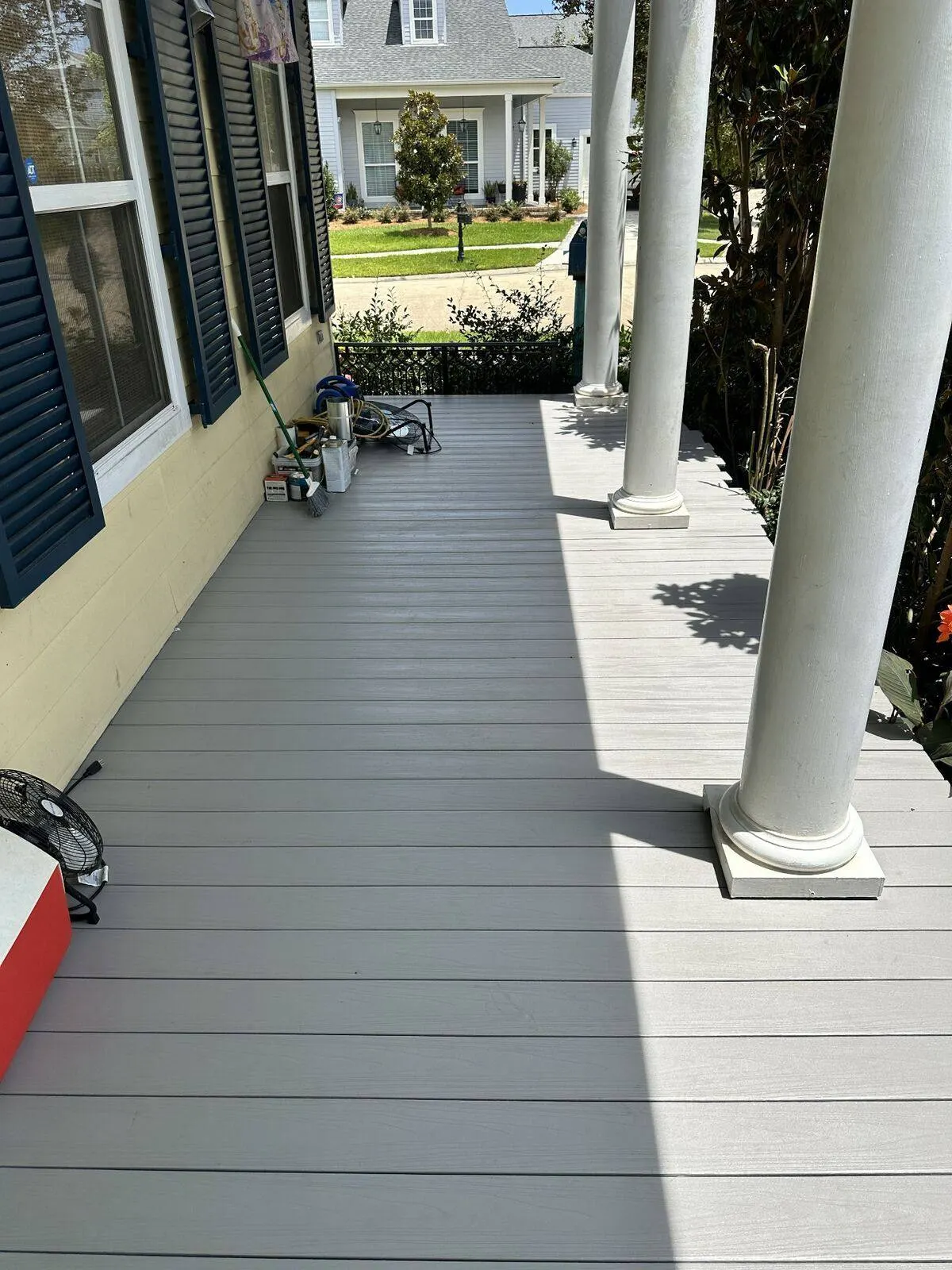 Completed composite deck with columns on historic yellow Victorian home in Algiers Point, New Orleans
