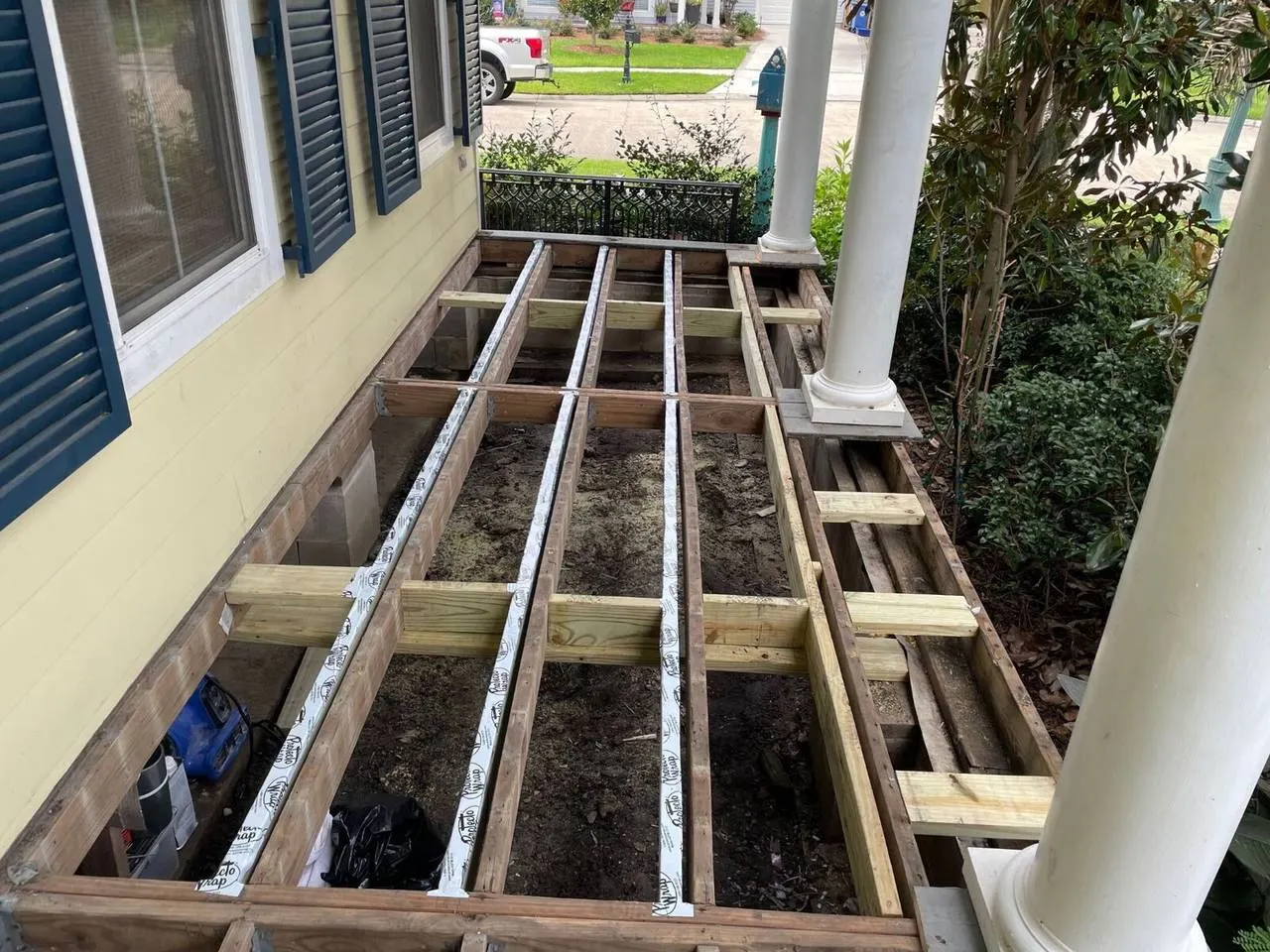 New pressure-treated deck framing with joist tape on historic Algiers Point home porch