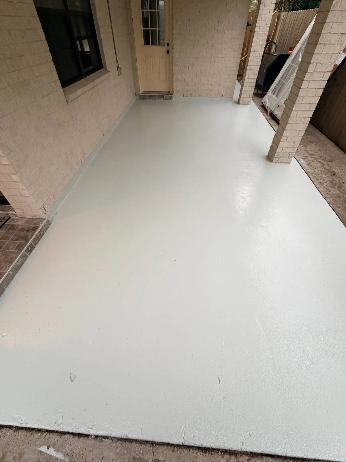 Backyard patio floor refinishing with epoxy coating in Metairie Louisiana