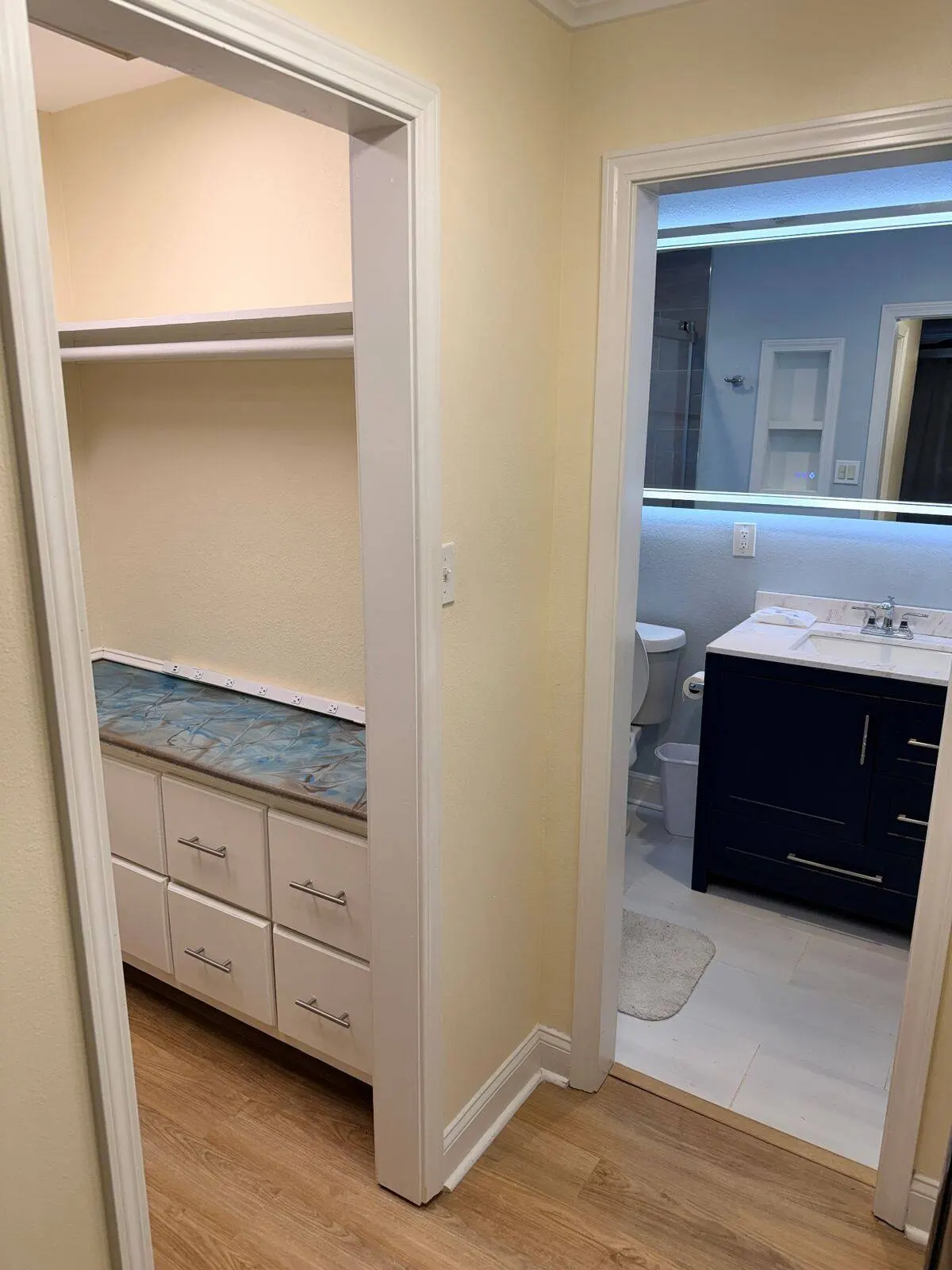Bathroom and closet remodel with LED mirror and custom drawers in Metairie home