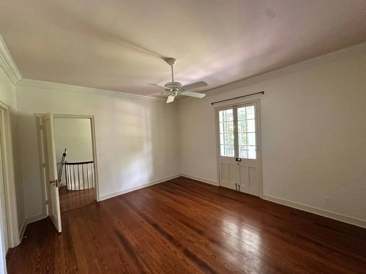 Bedroom remodel with refinished hardwood flooring and ceiling fan in Covington LA