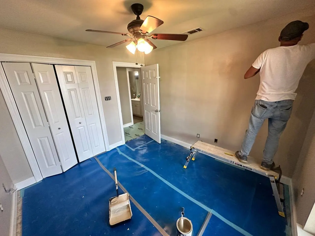 Bedroom with floors protected for painting in Gonzales LA
