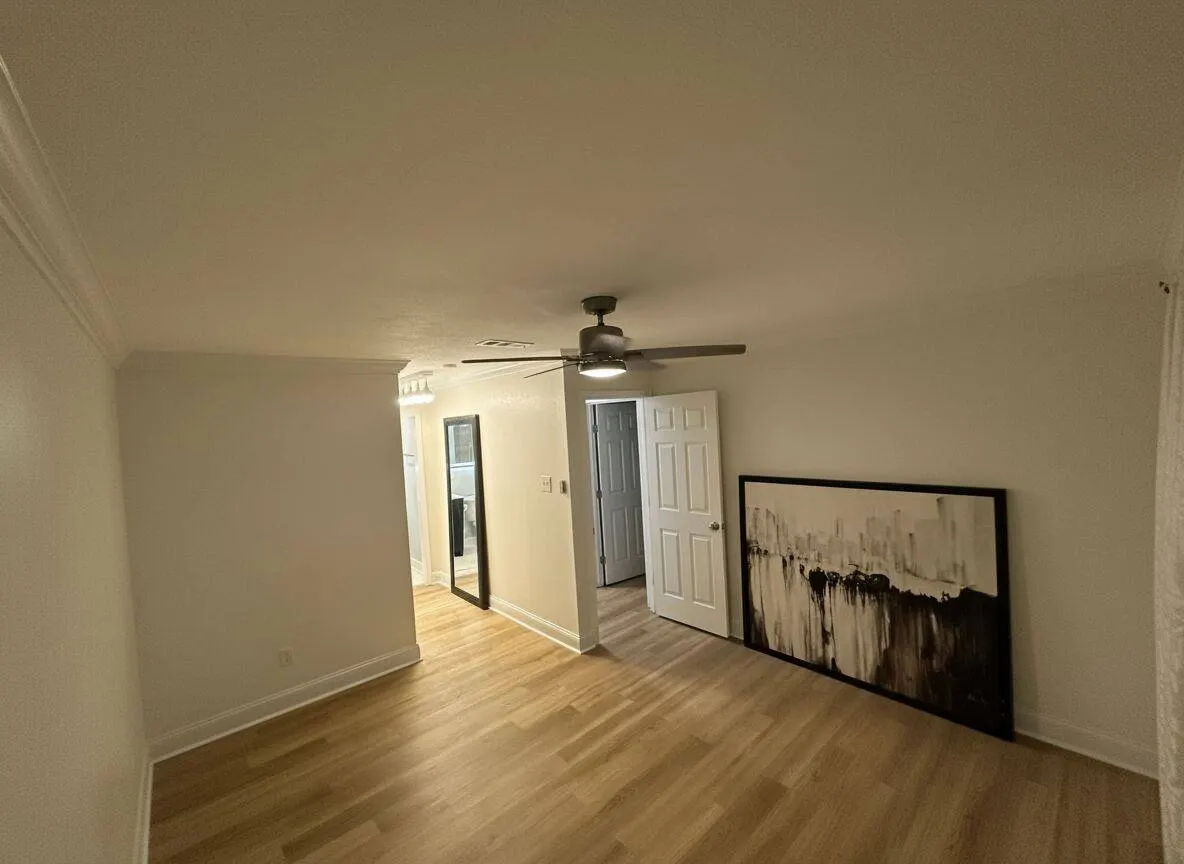 Bedroom remodel with new flooring installation and ceiling fan in Metairie LA