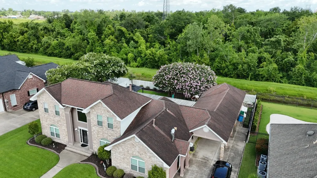 Aerial view of aging brittle shingle roof on a Destrehan Louisiana brick home before re-roof replacement by Cajun Home Services