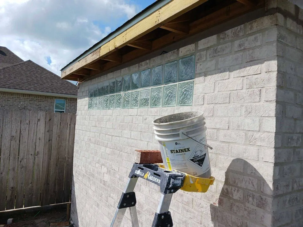 Glass block window detail set in custom brick masonry shed wall in Meraux, Louisiana