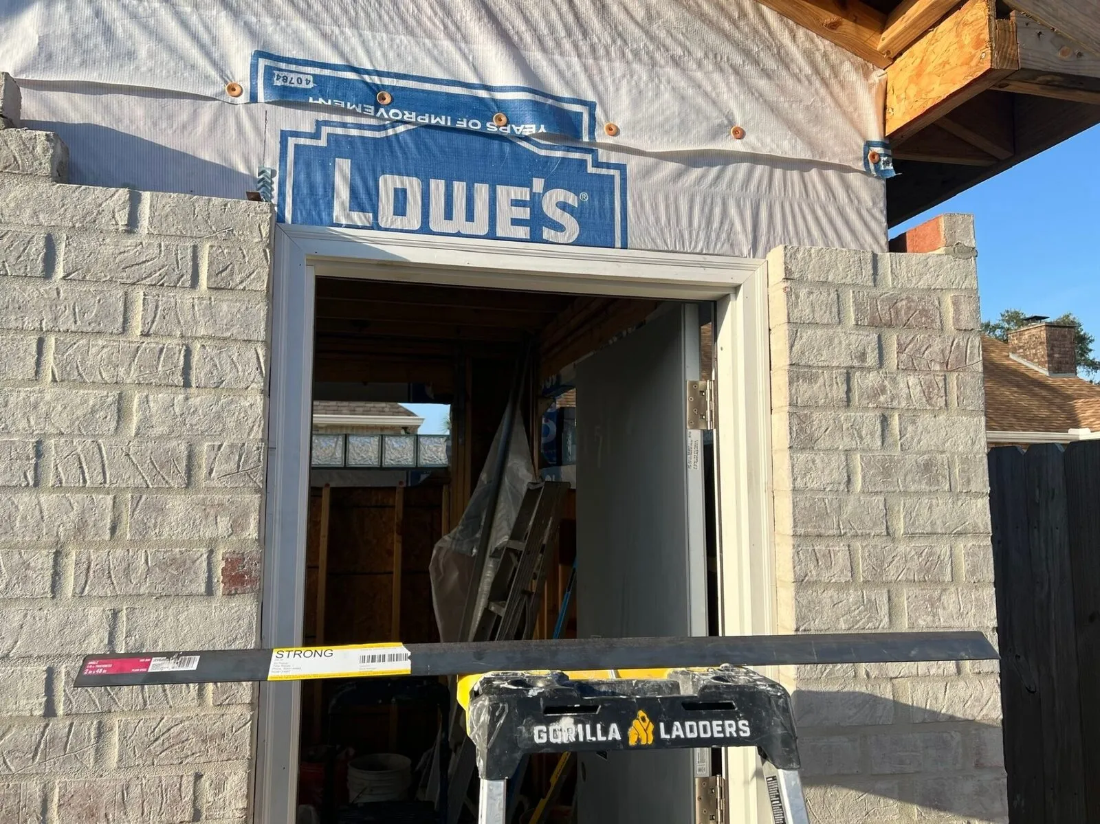 Brick masonry door surround with housewrap above gable on custom shed in Meraux Louisiana