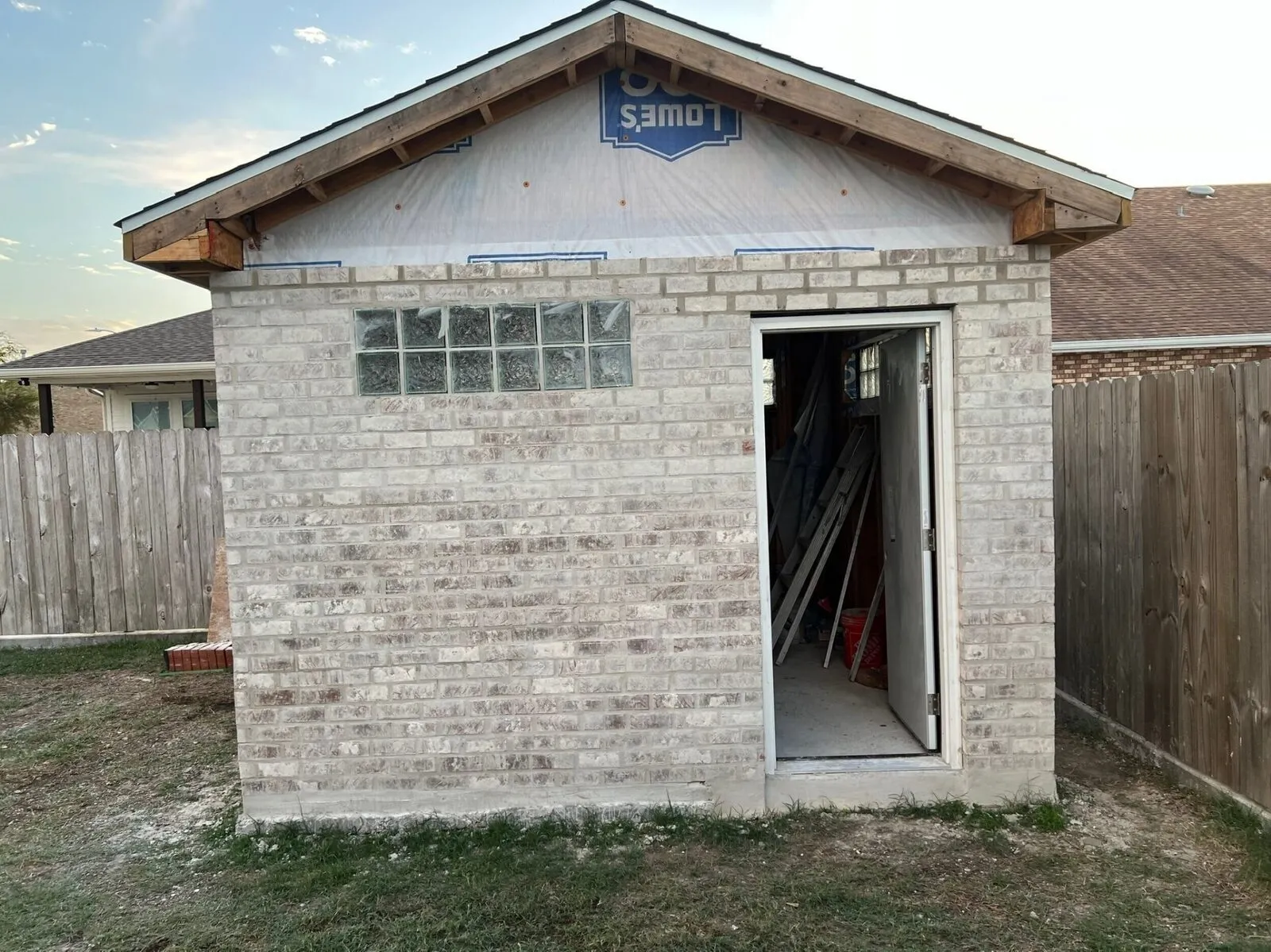 Custom brick masonry shed with glass block window built by Cajun Home Services in Meraux, Louisiana